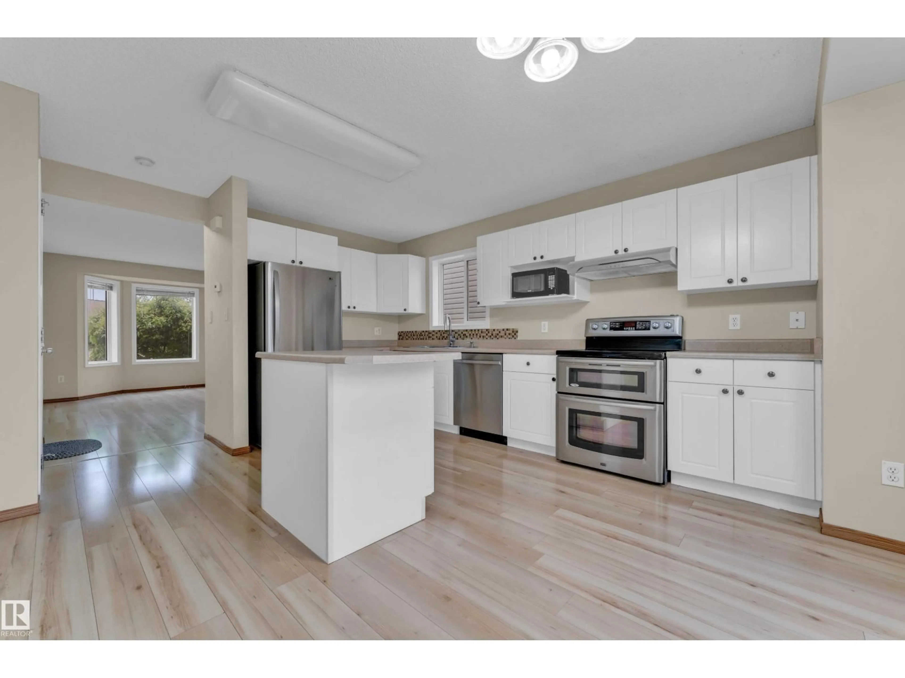 Open concept kitchen, wood/laminate floor for 3134 30 AV, Edmonton Alberta T6T1T9
