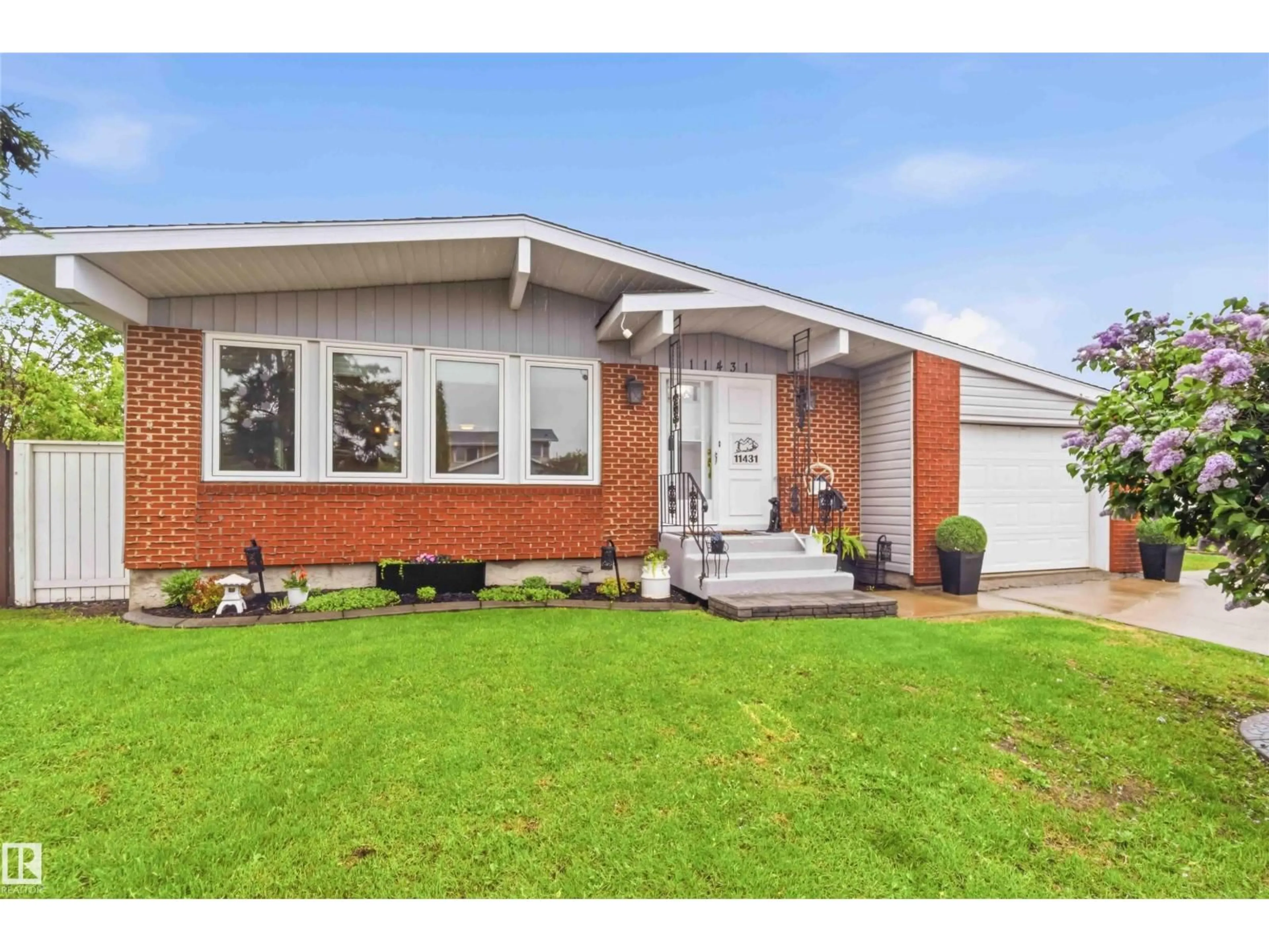 Home with brick exterior material, street for 11431 144 AV, Edmonton Alberta T5X1L7
