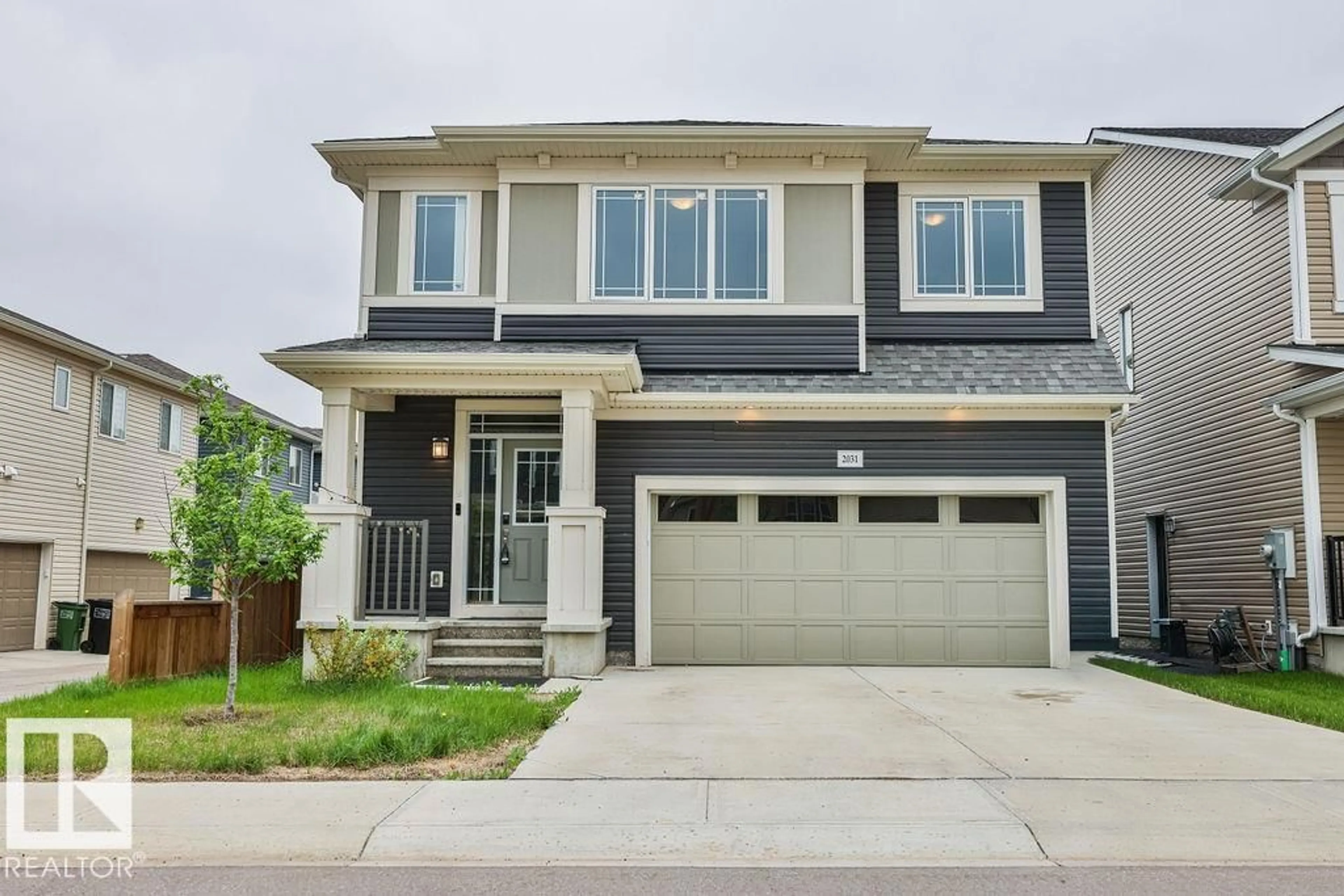 Home with vinyl exterior material, street for 2031 207 ST, Edmonton Alberta T6M1R7