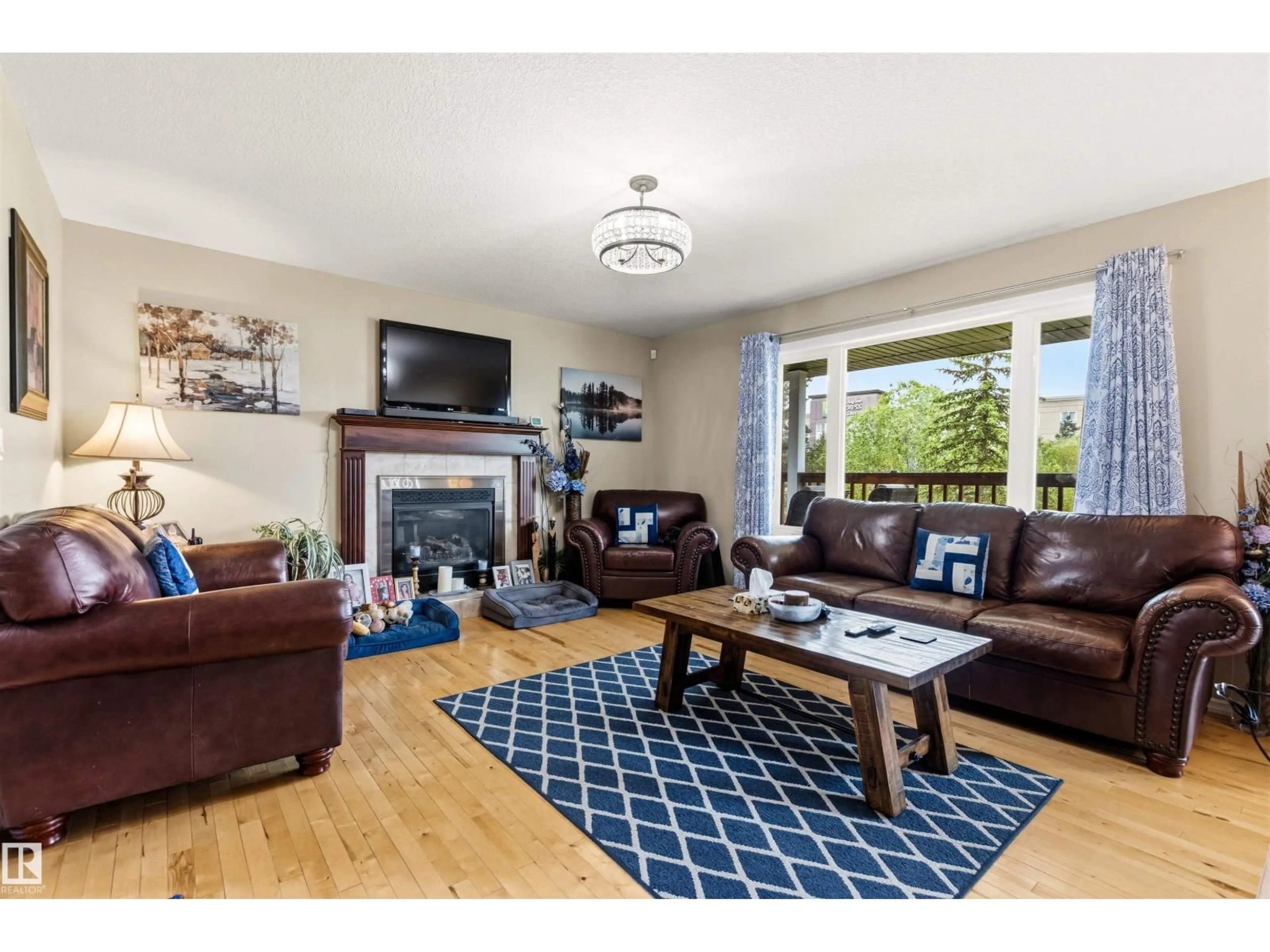 Living room with furniture, wood/laminate floor for 32 LAMPLIGHT BA, Spruce Grove Alberta T7X4N2