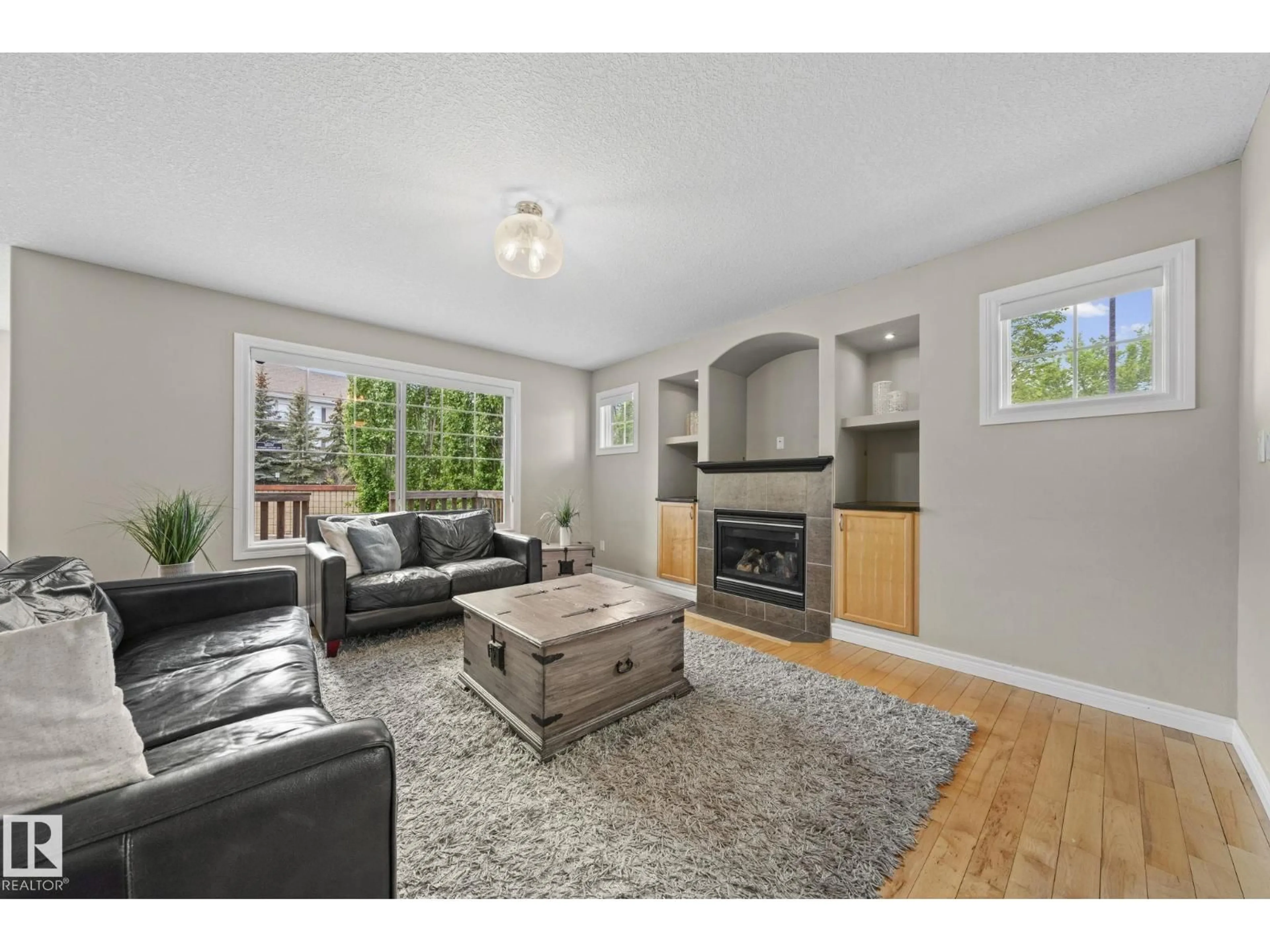 Living room with furniture, wood/laminate floor for 8097 SHASKE DR, Edmonton Alberta T6R0B6