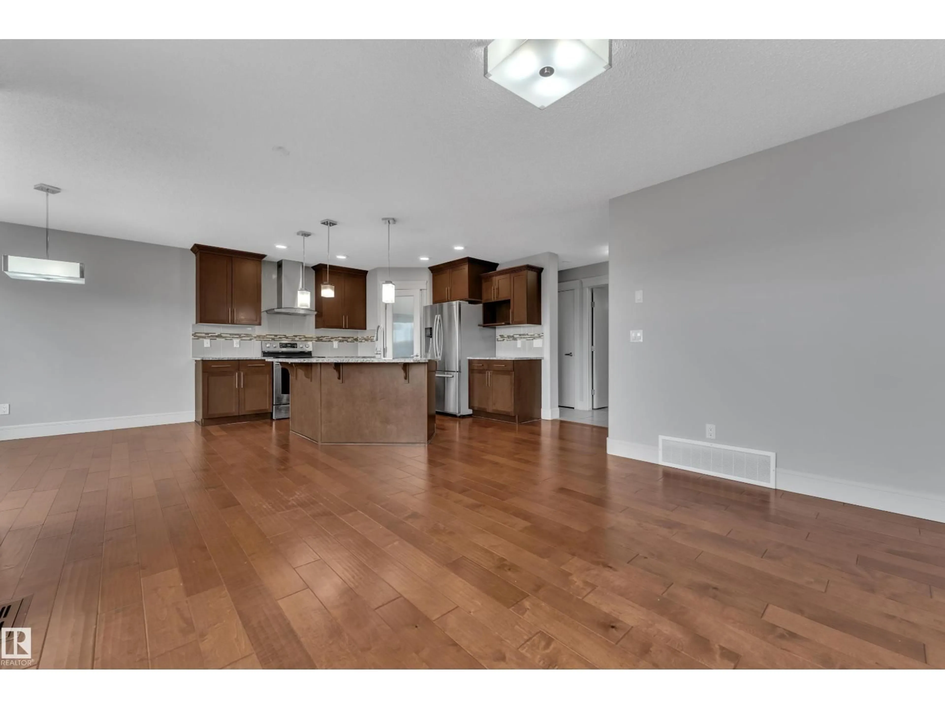 Open concept kitchen, wood/laminate floor for 3363 13 AVE, Edmonton Alberta T6T0Z4