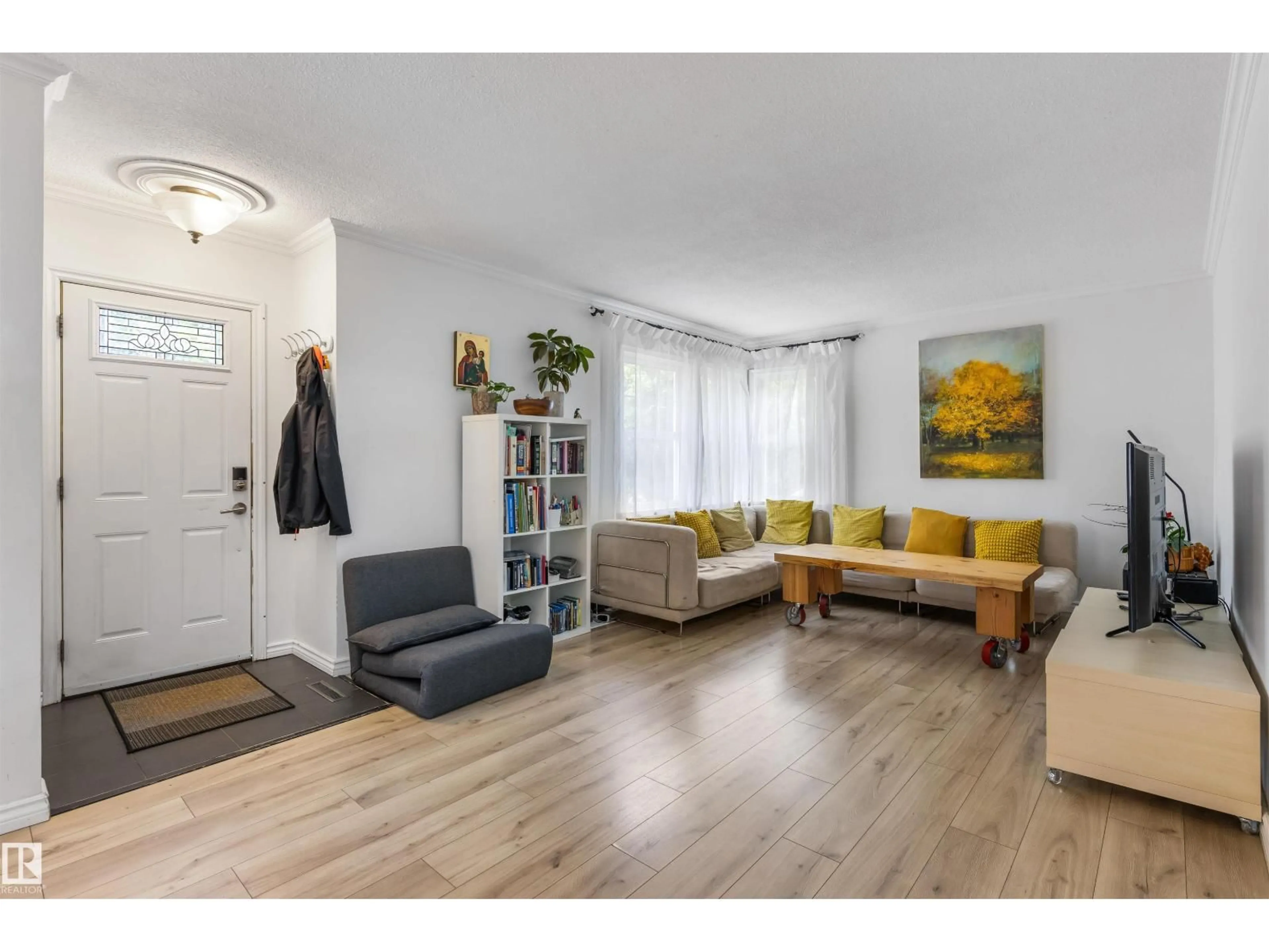 Living room with furniture, wood/laminate floor for 14007 104 AV, Edmonton Alberta T5N0W7