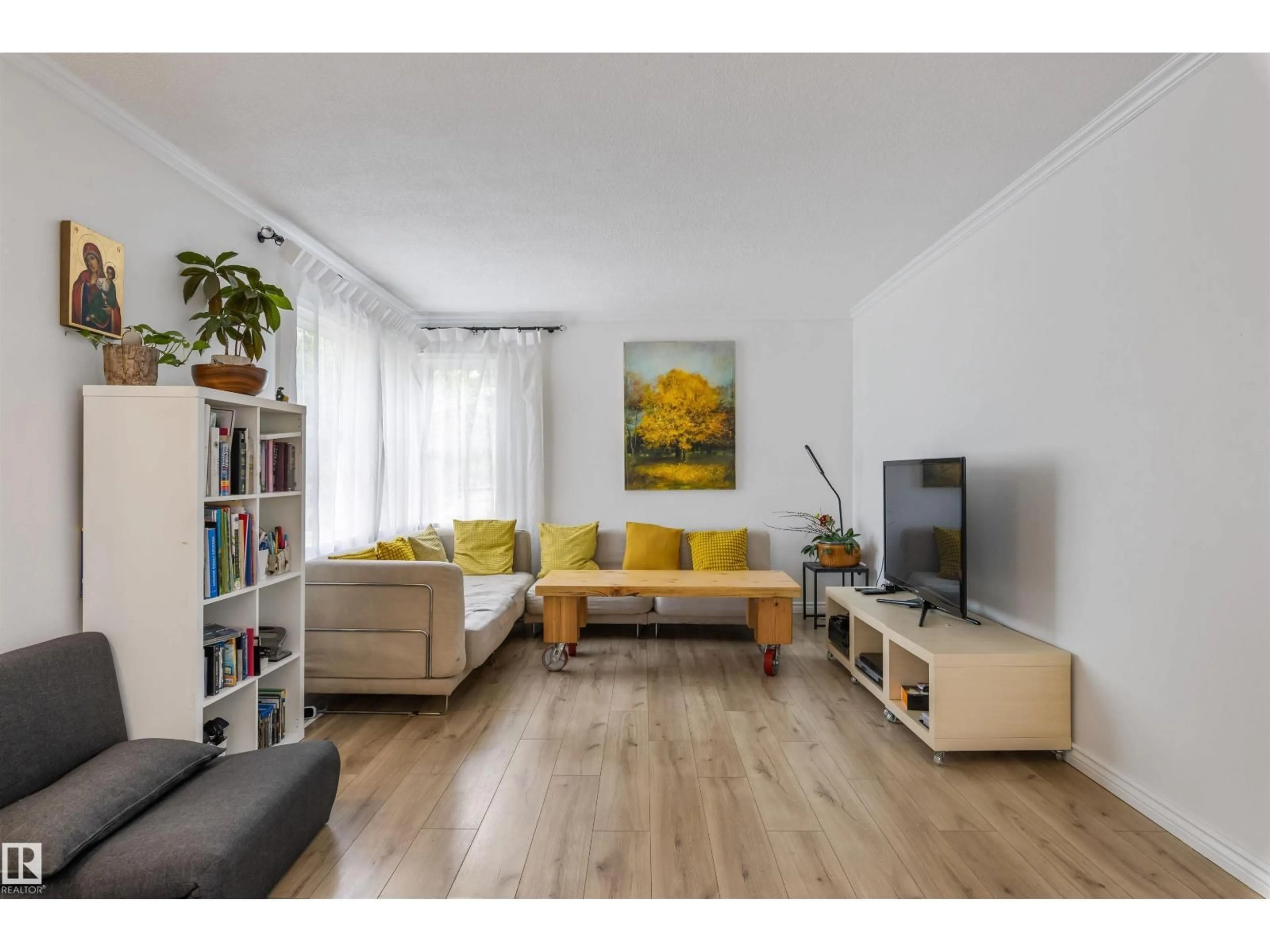 Living room with furniture, wood/laminate floor for 14007 104 AV, Edmonton Alberta T5N0W7