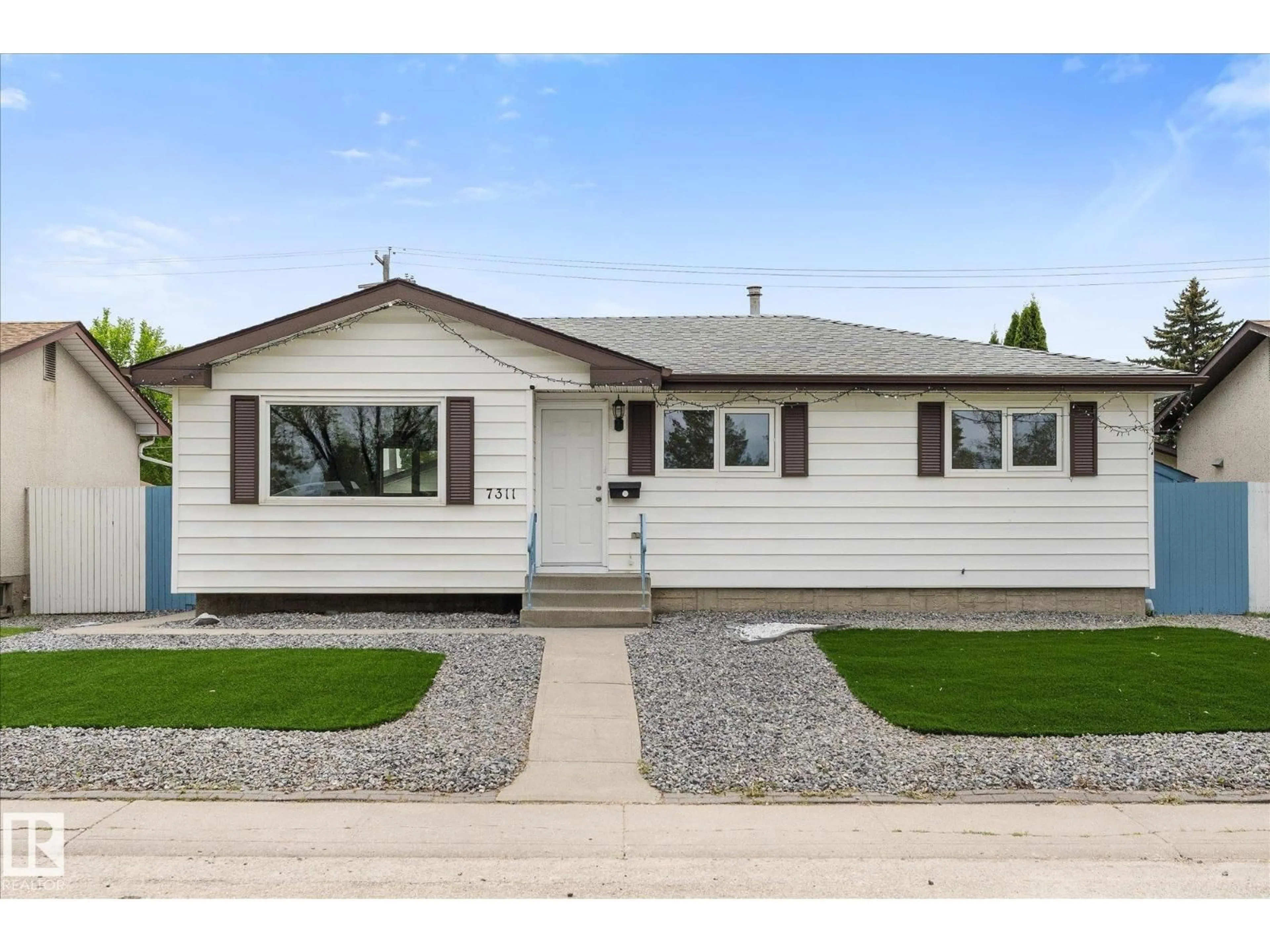 Home with vinyl exterior material, street for 7311 137 AV, Edmonton Alberta T5C2L4