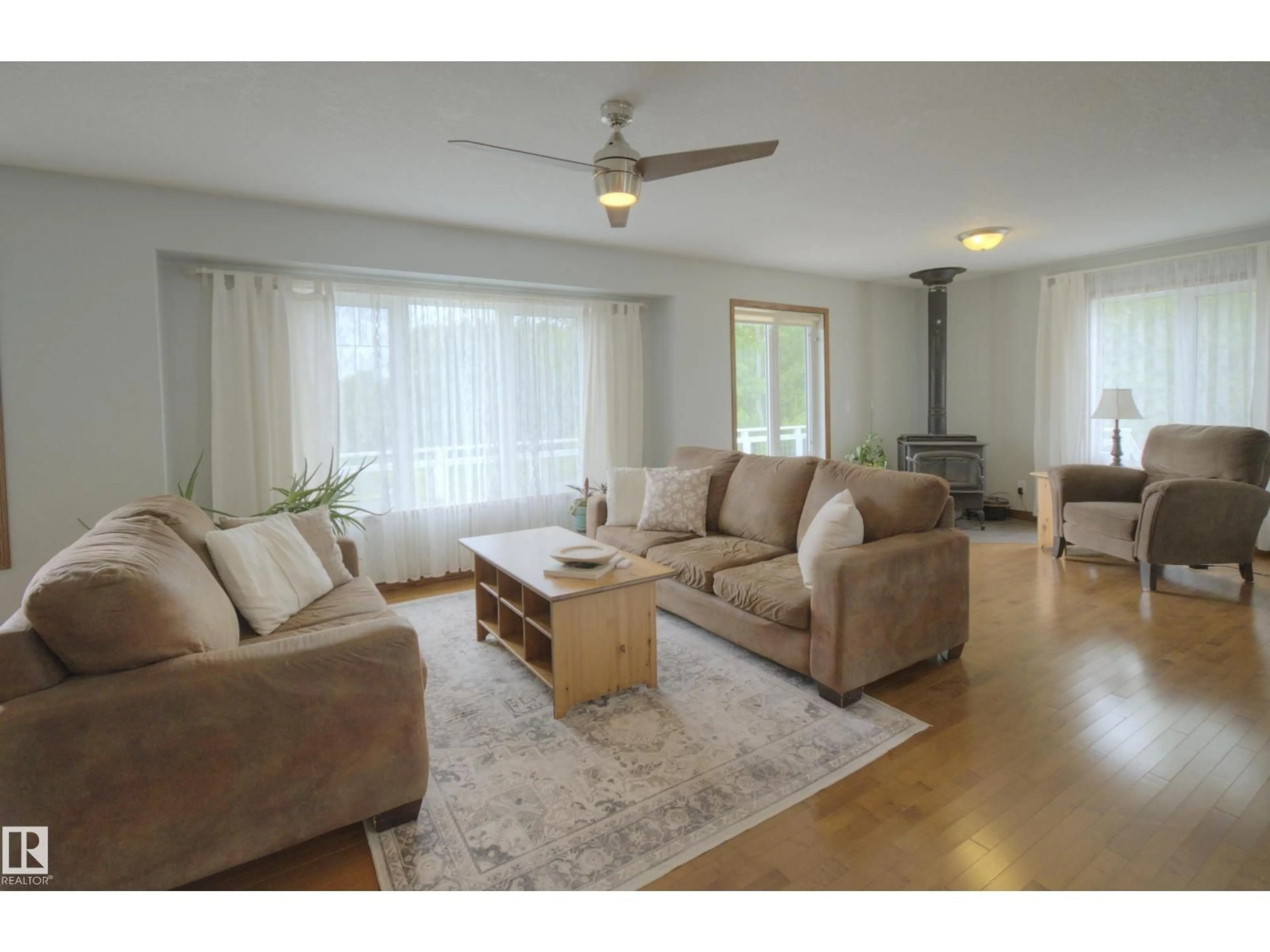 Living room with furniture, wood/laminate floor for 1213 TWP ROAD 554, Rural Lac Ste. Anne County Alberta T0E1V0