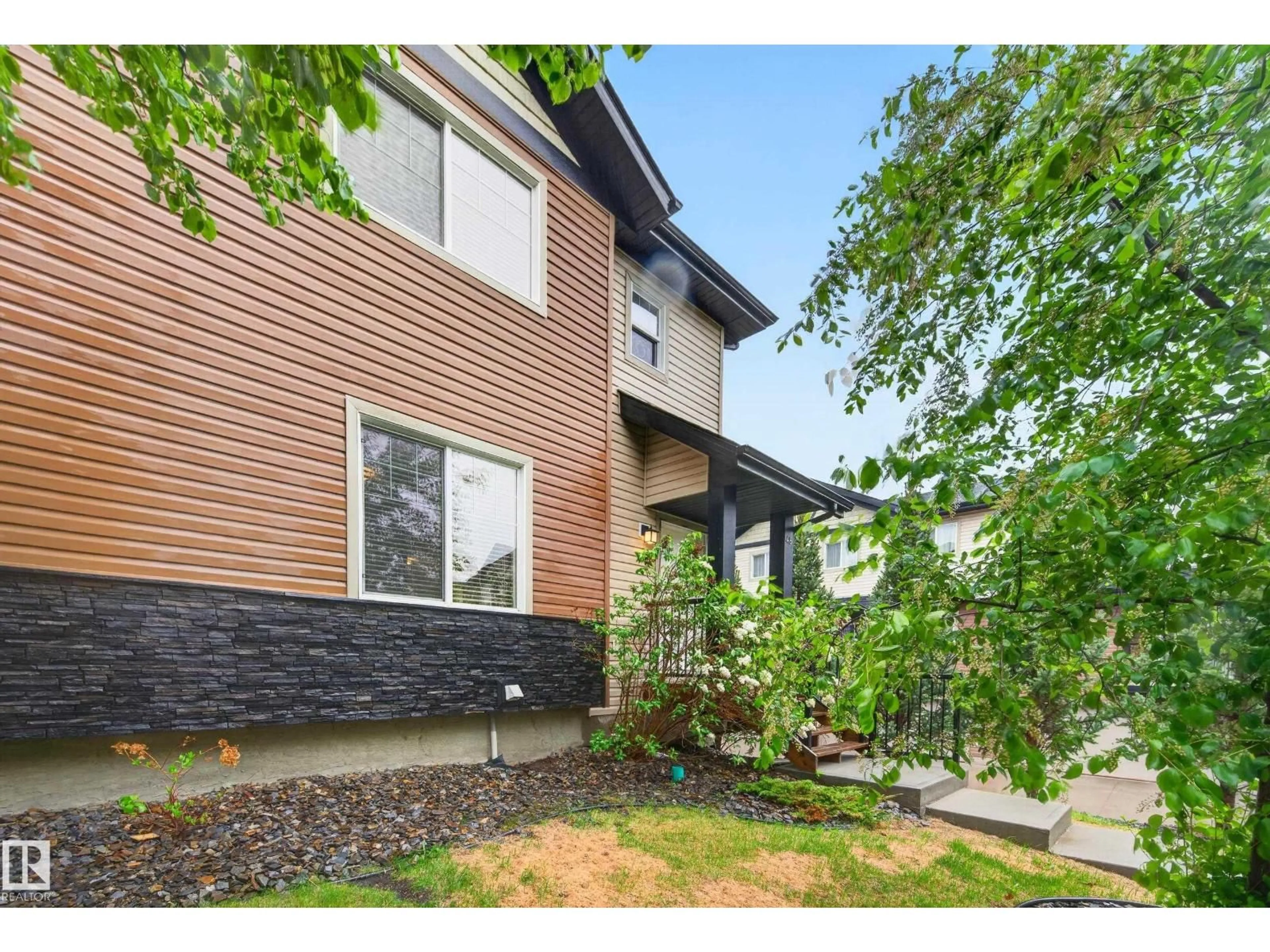 Home with vinyl exterior material, street for #48 - 8716 179 AV, Edmonton Alberta T5Z0J3