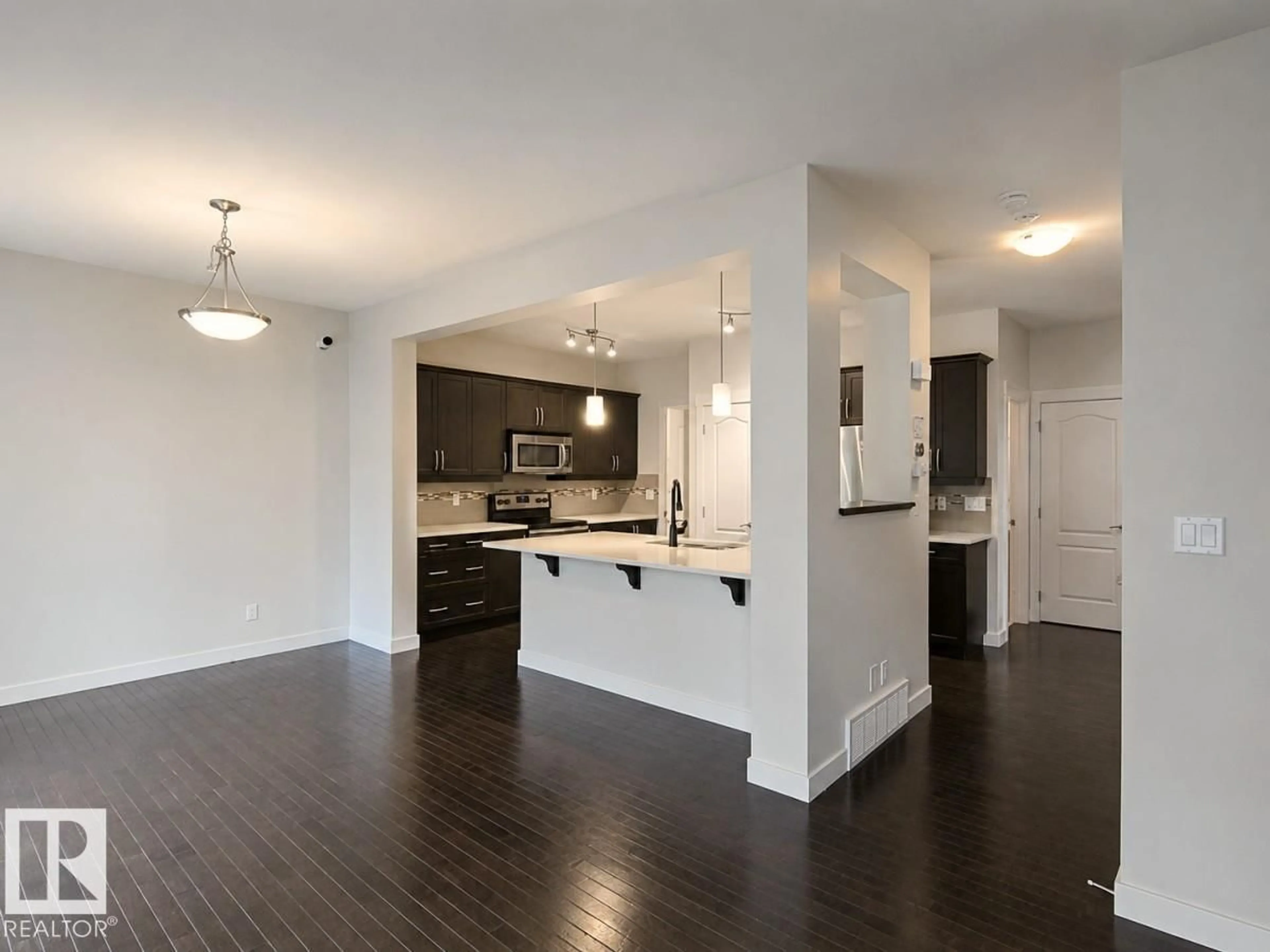 Open concept kitchen, wood/laminate floor for 1227 SECORD LANDING LD, Edmonton Alberta T5T4N3