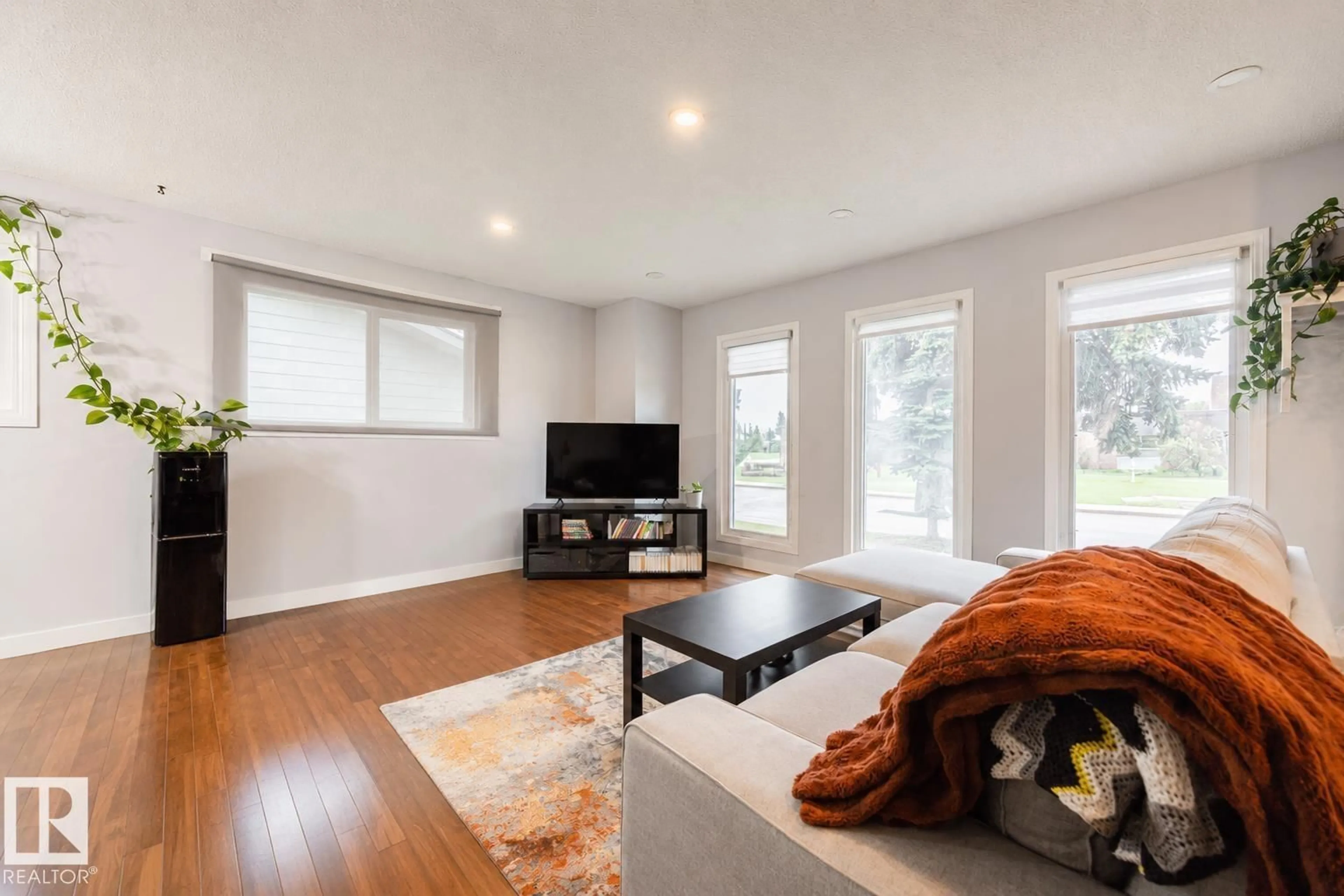 Living room with furniture, wood/laminate floor for 17932 93 AV, Edmonton Alberta T5T1V6