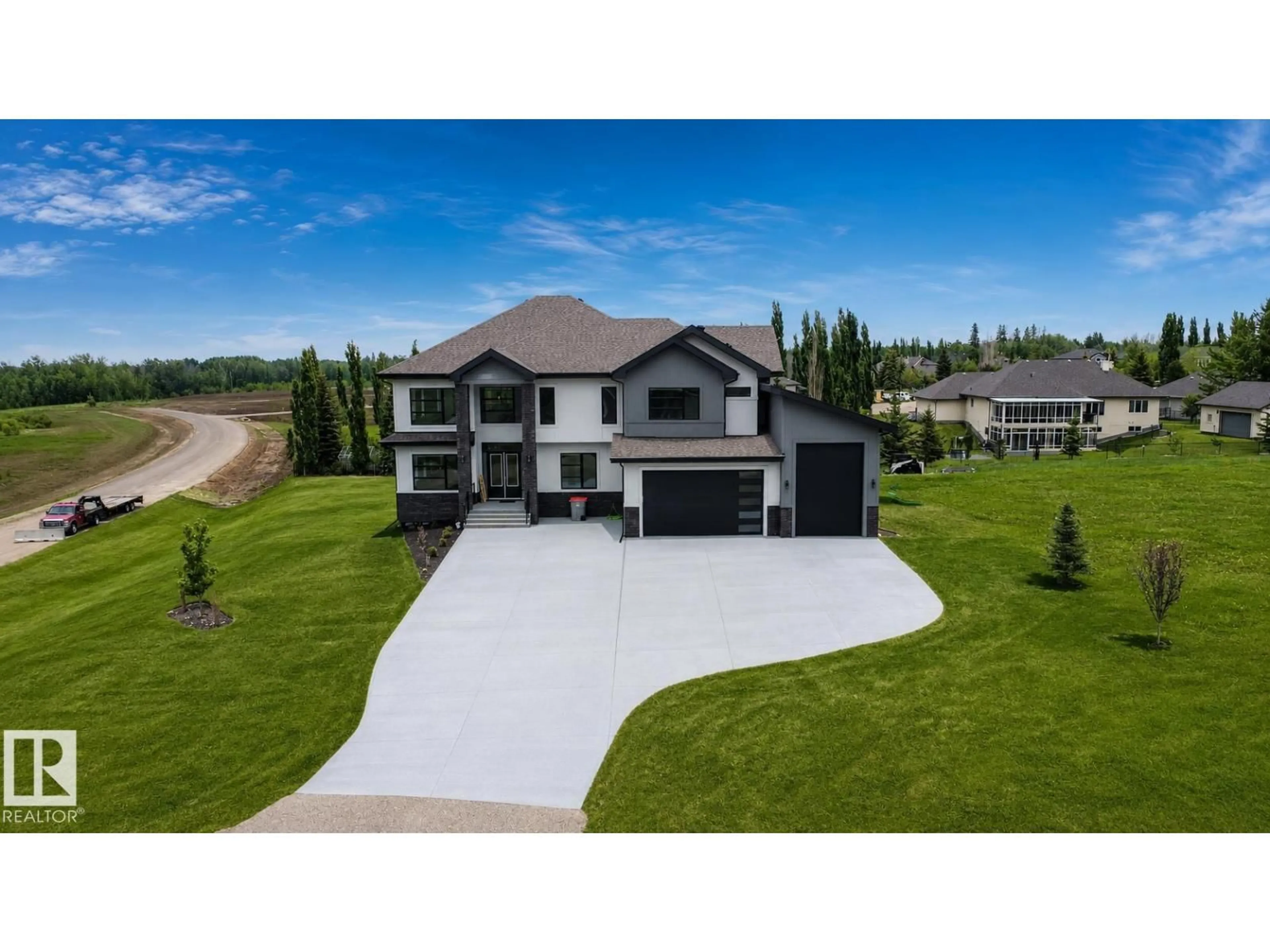 A pic from outside/outdoor area/front of a property/back of a property/a pic from drone, street for #83 - 26131 TWP ROAD 532 A, Rural Parkland County Alberta T7Y1A1