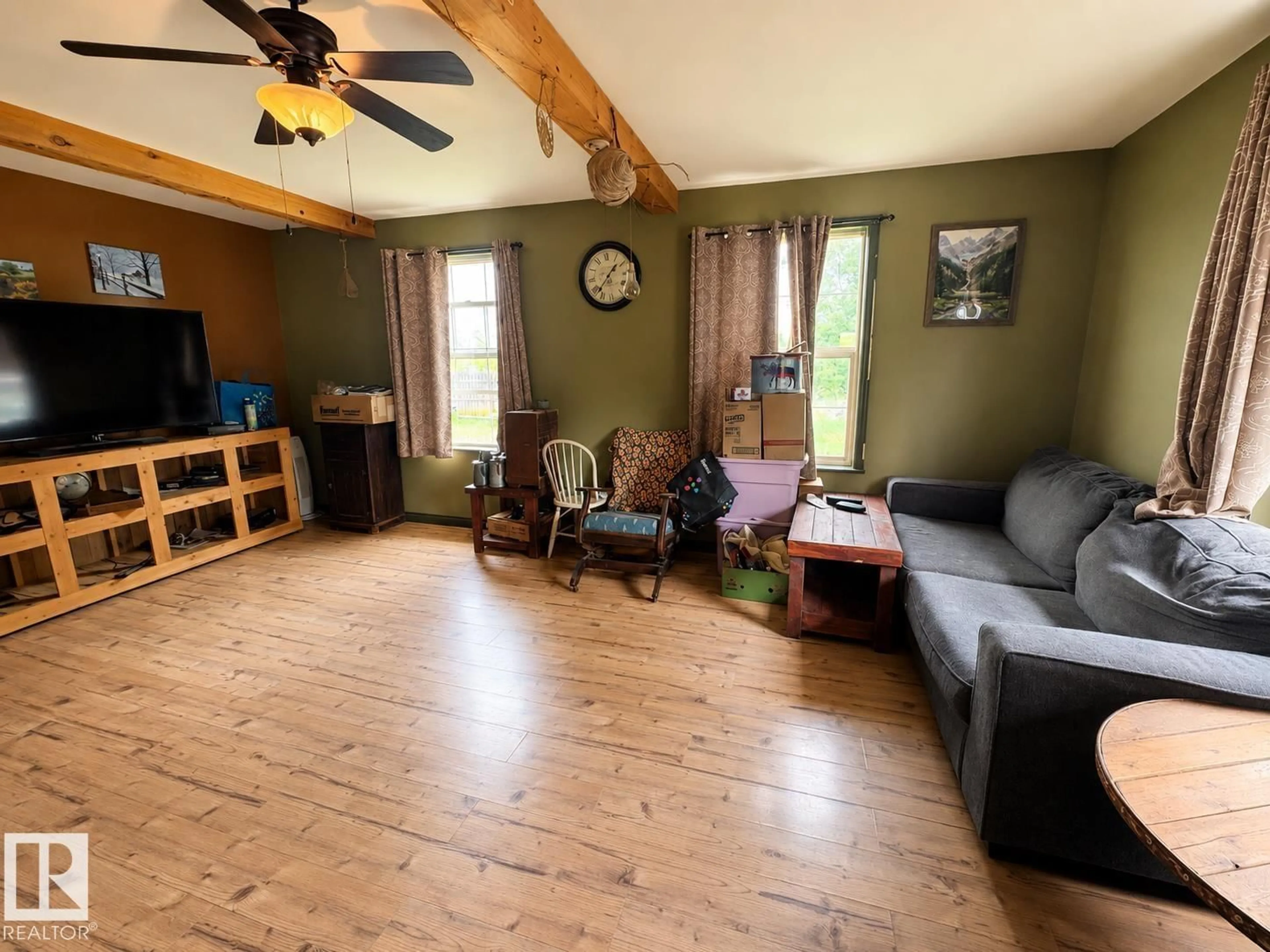 Living room with furniture, wood/laminate floor for 63102 RGE RD 451, Rural Bonnyville M.D. Alberta T9N2J6
