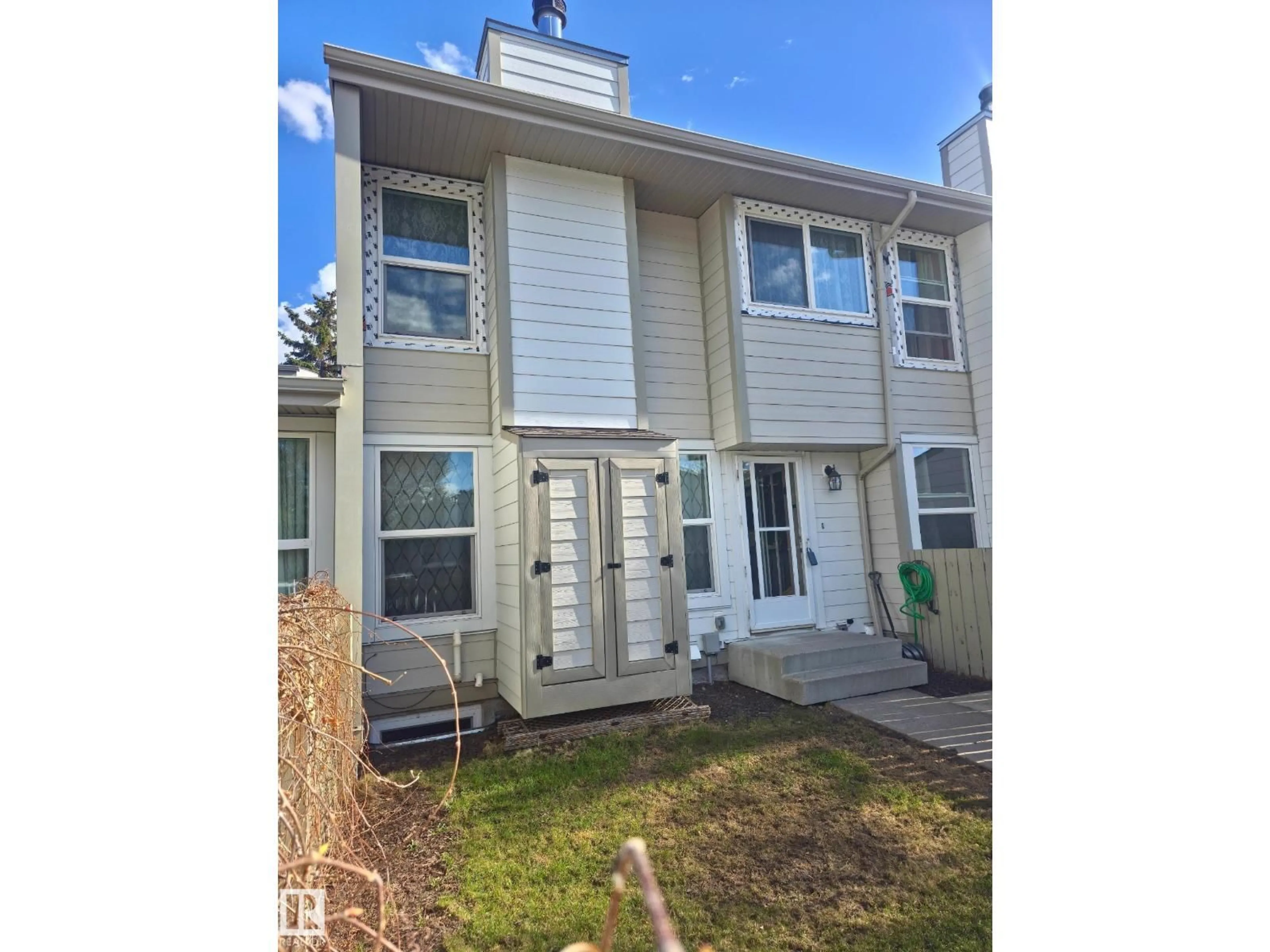 Home with vinyl exterior material, street for 1128 KNOTTWOOD RD E NW, Edmonton Alberta T6K2J8