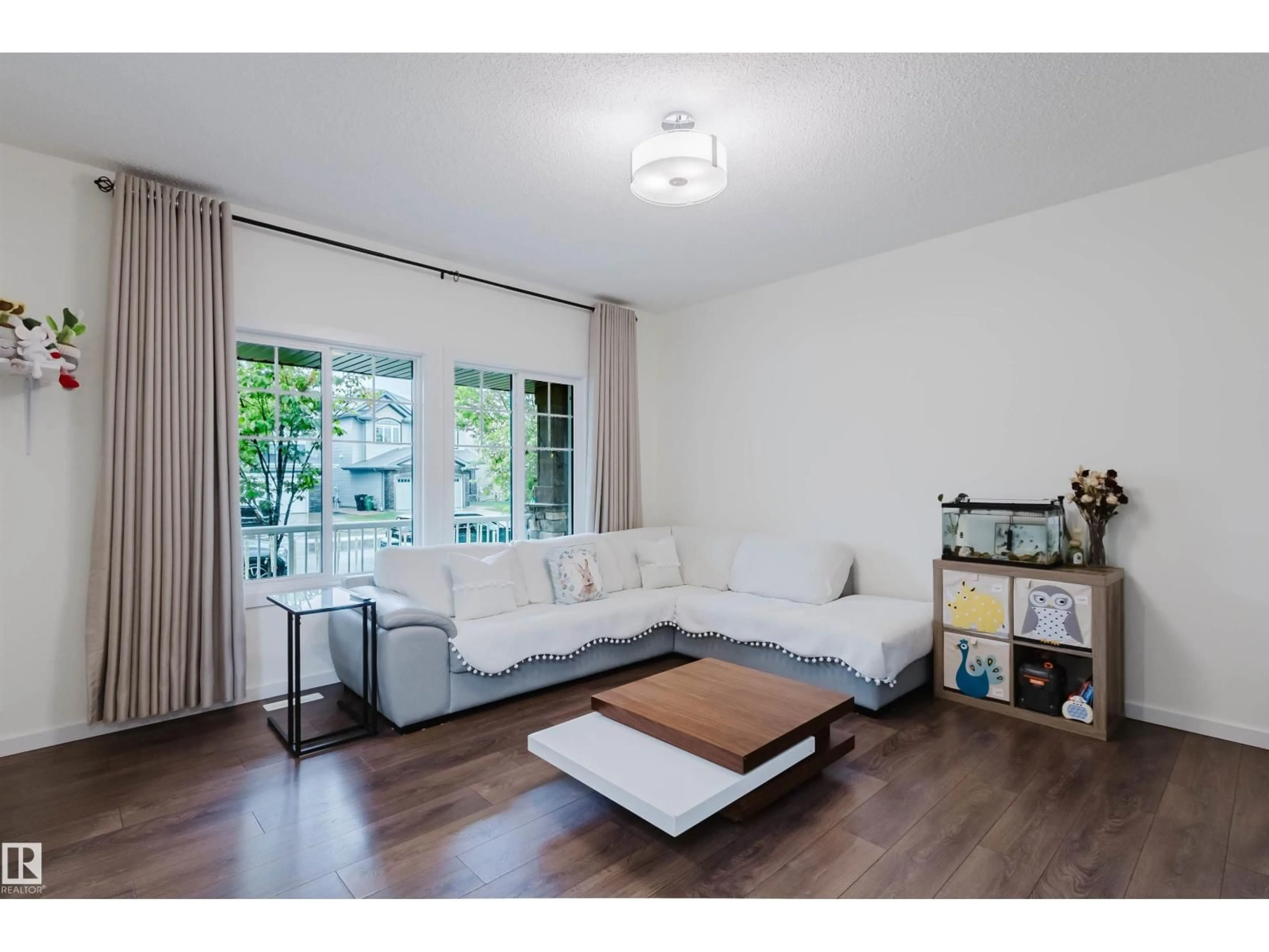 Living room with furniture, wood/laminate floor for 2124 GLENRIDDING WY, Edmonton Alberta T6W2H4