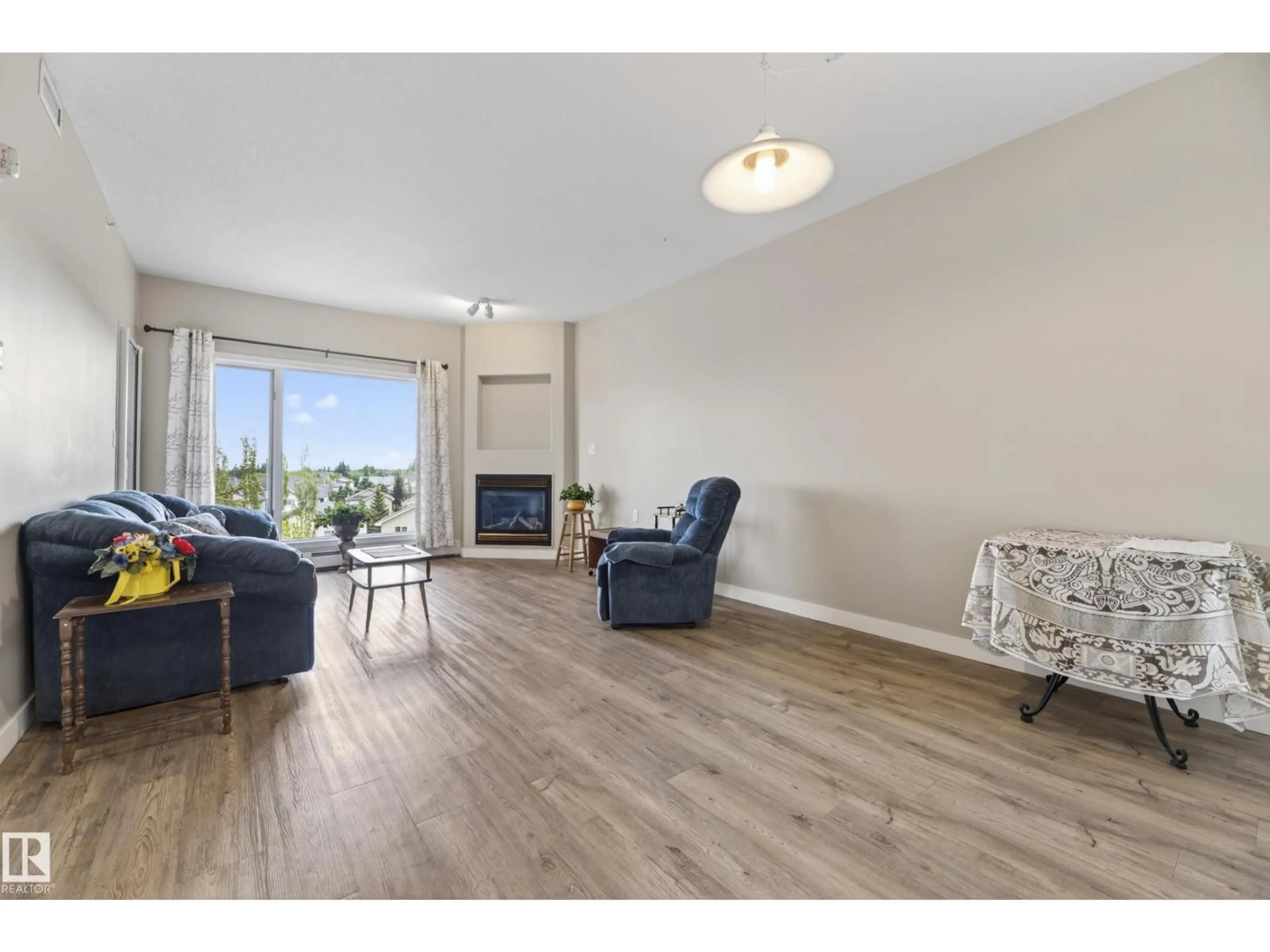 Living room with furniture, wood/laminate floor for 200 - 427 BETHEL DR, Sherwood Park Alberta T8H2C5