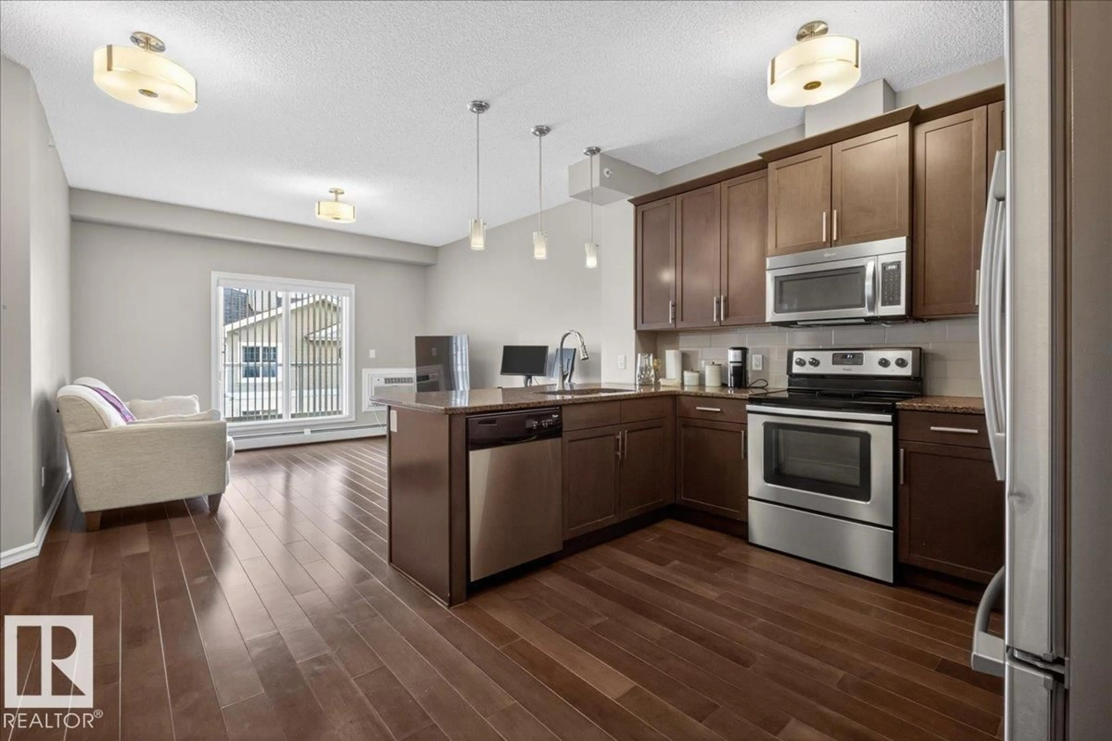 Open concept kitchen, wood/laminate floor for #413 - 2203 44 AV NW, Edmonton Alberta T6T0T1