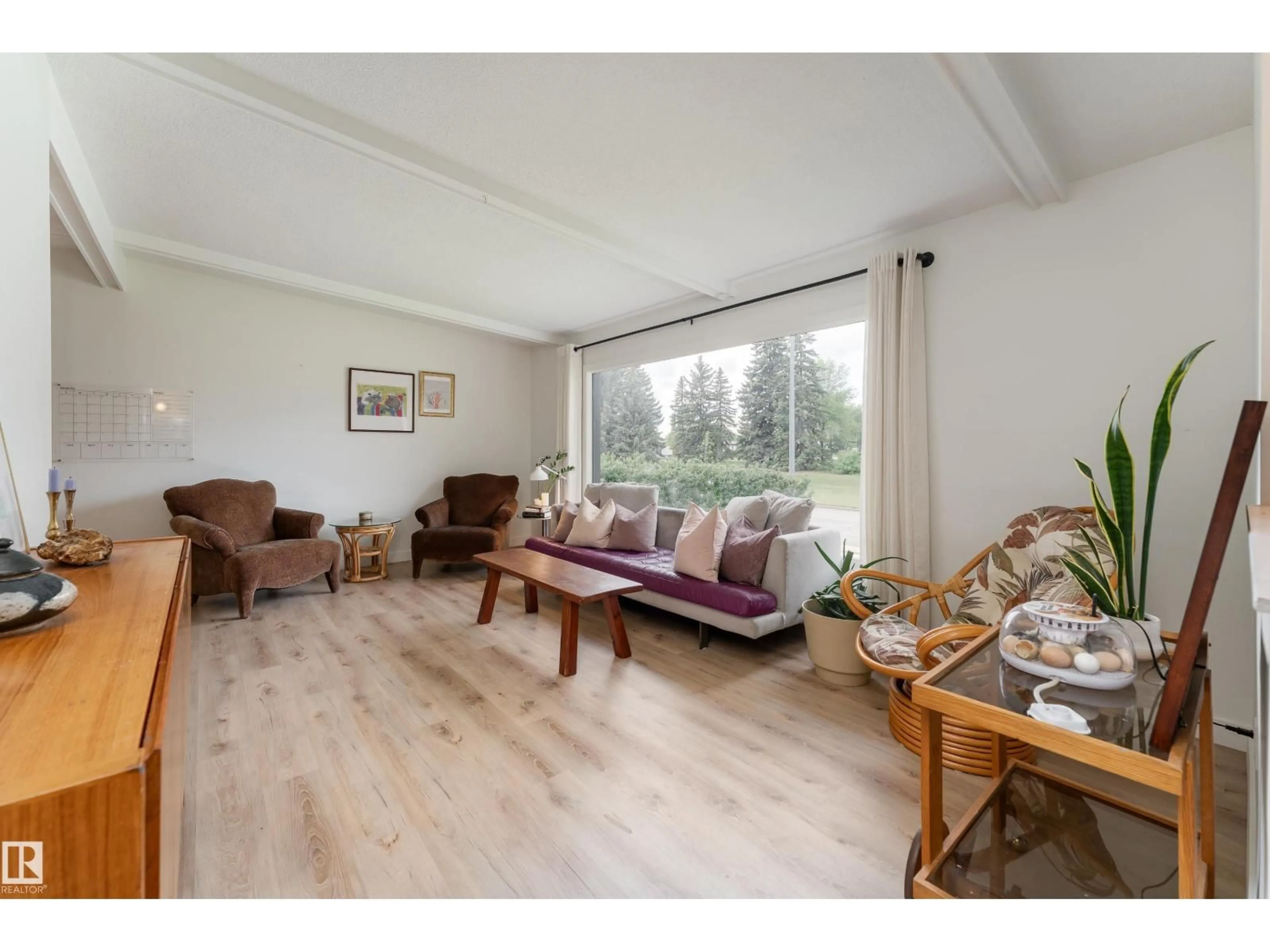 Living room with furniture, wood/laminate floor for 7107 87 AV, Edmonton Alberta T6B0L6