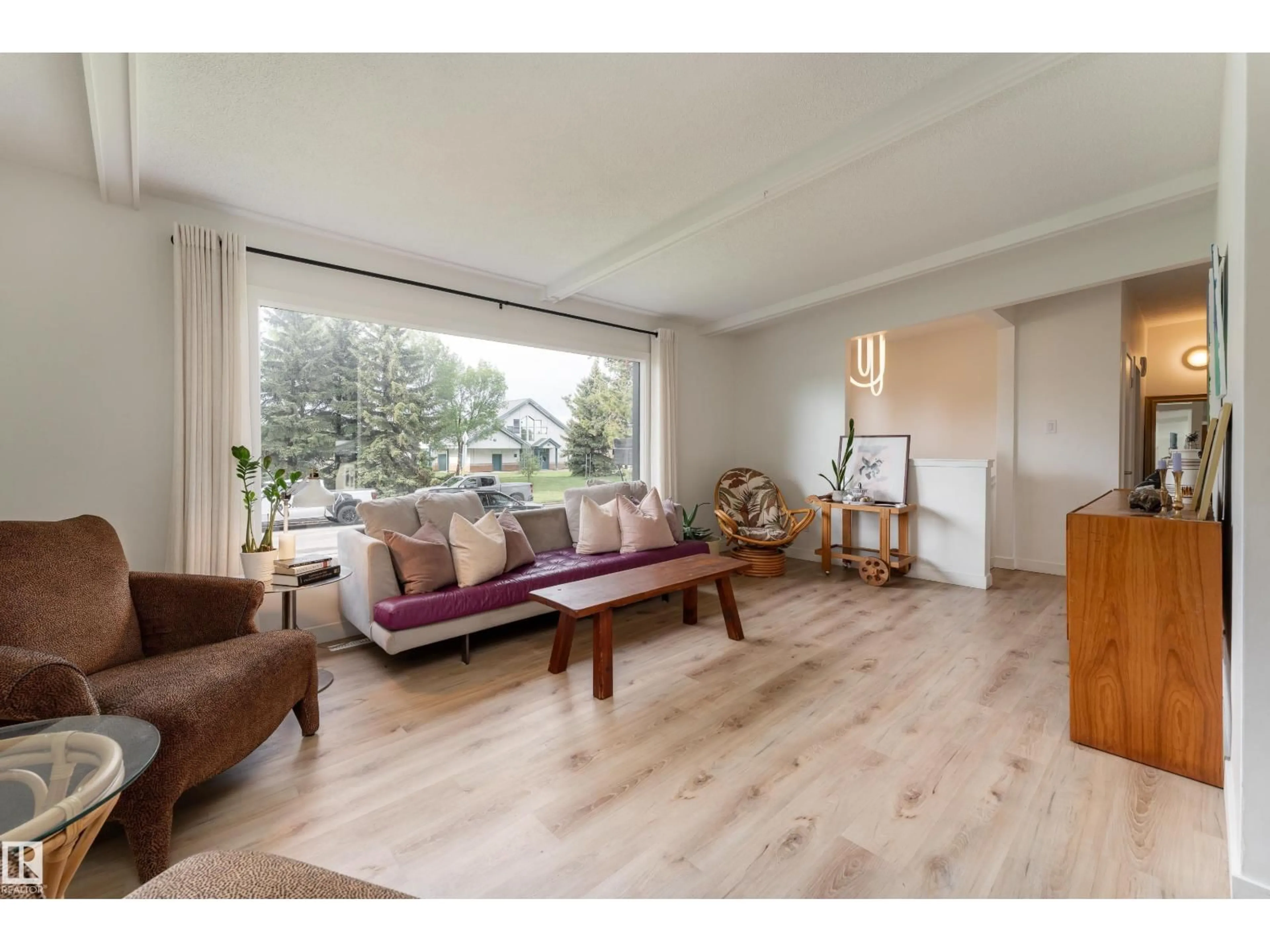 Living room with furniture, wood/laminate floor for 7107 87 AV, Edmonton Alberta T6B0L6