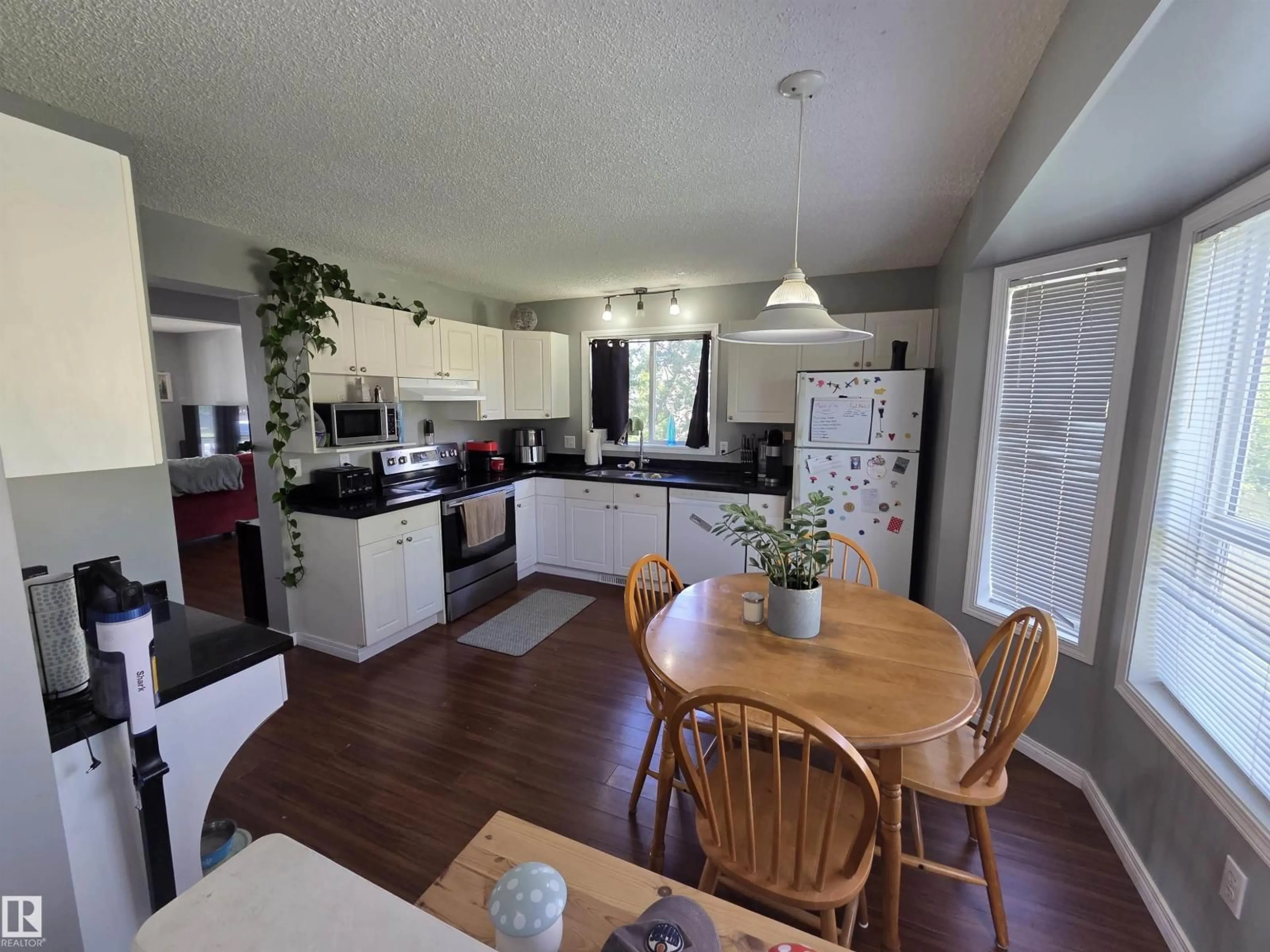 Open concept kitchen, wood/laminate floor for 919 NORMANDY LN, Sherwood Park Alberta T8A5X7