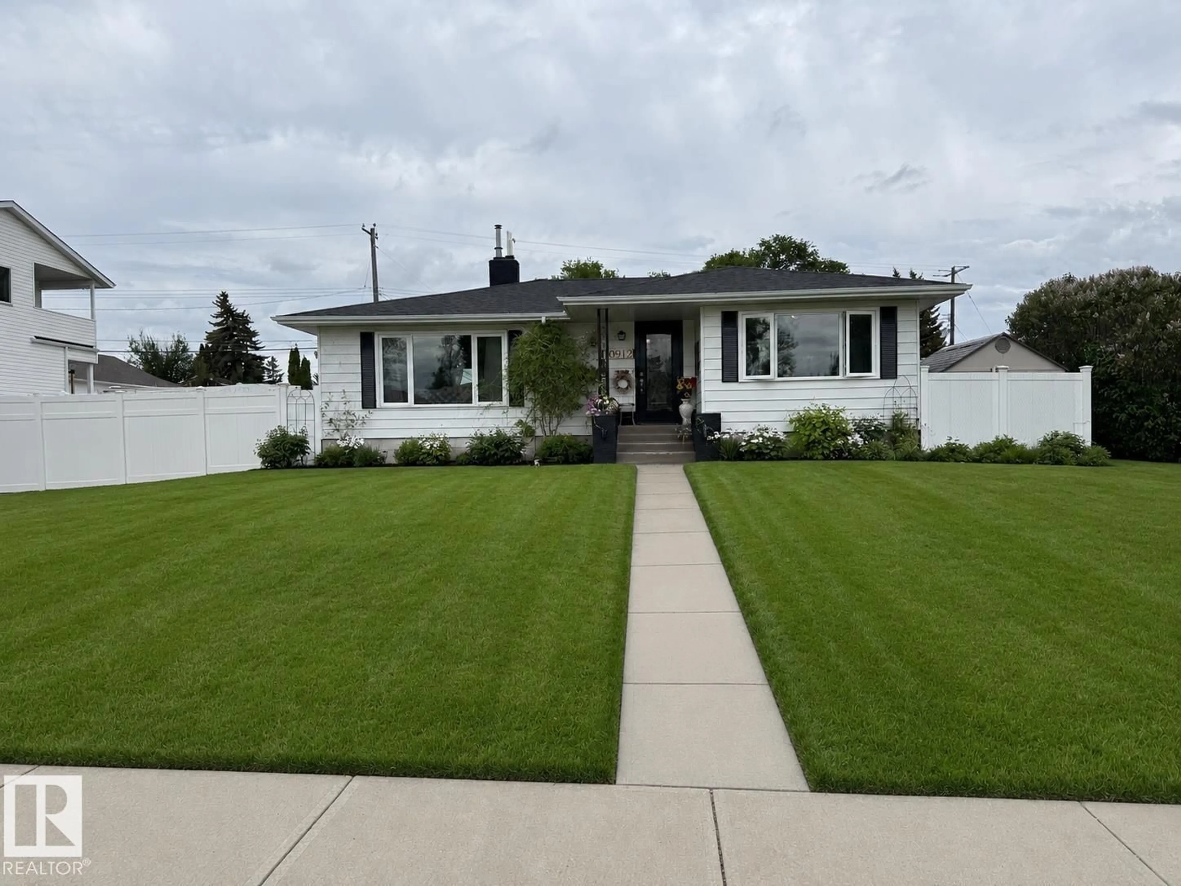 Home with vinyl exterior material, street for NW - 10912 50 ST, Edmonton Alberta T6A2E8
