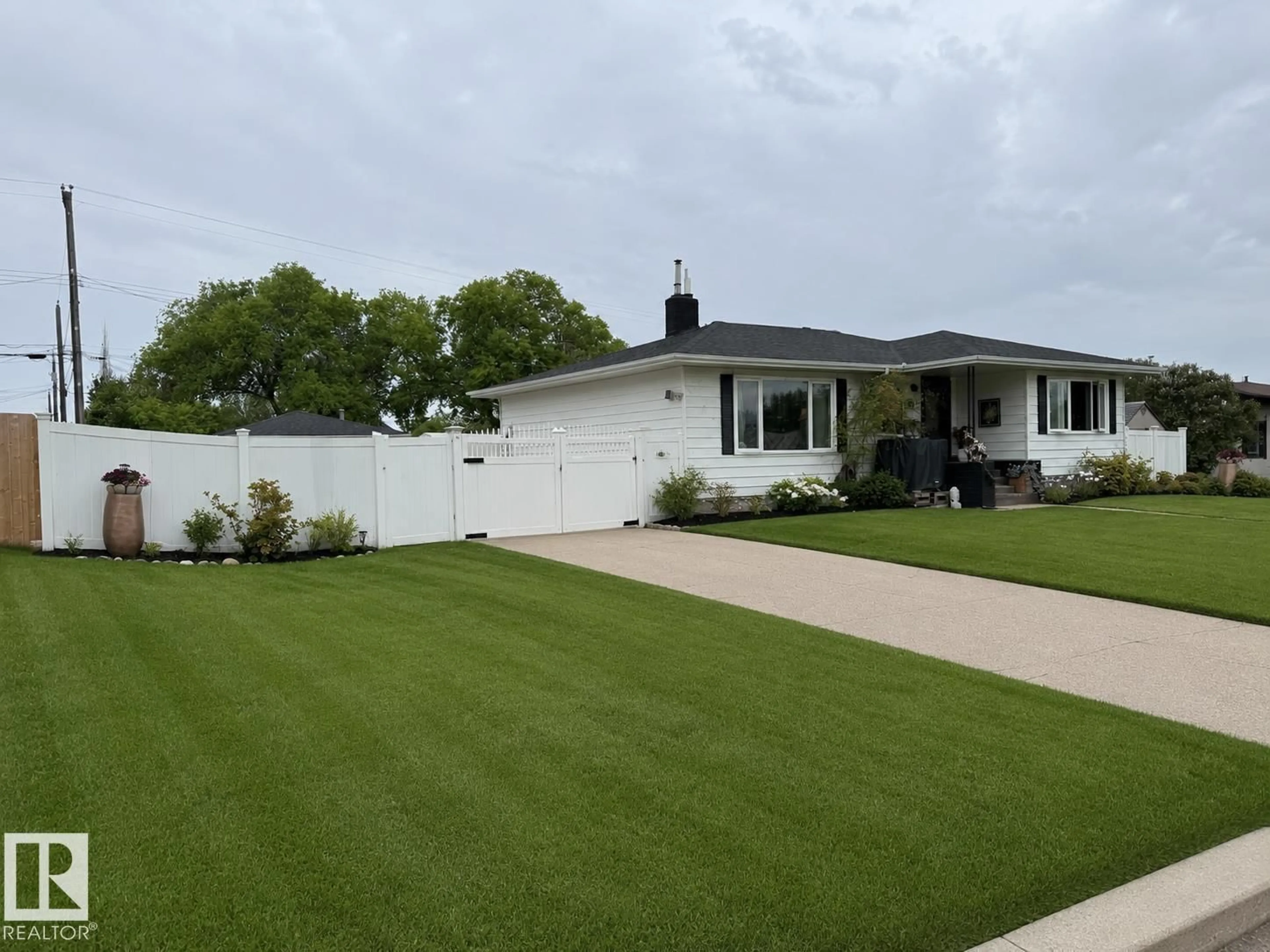 Home with vinyl exterior material, street for NW - 10912 50 ST, Edmonton Alberta T6A2E8