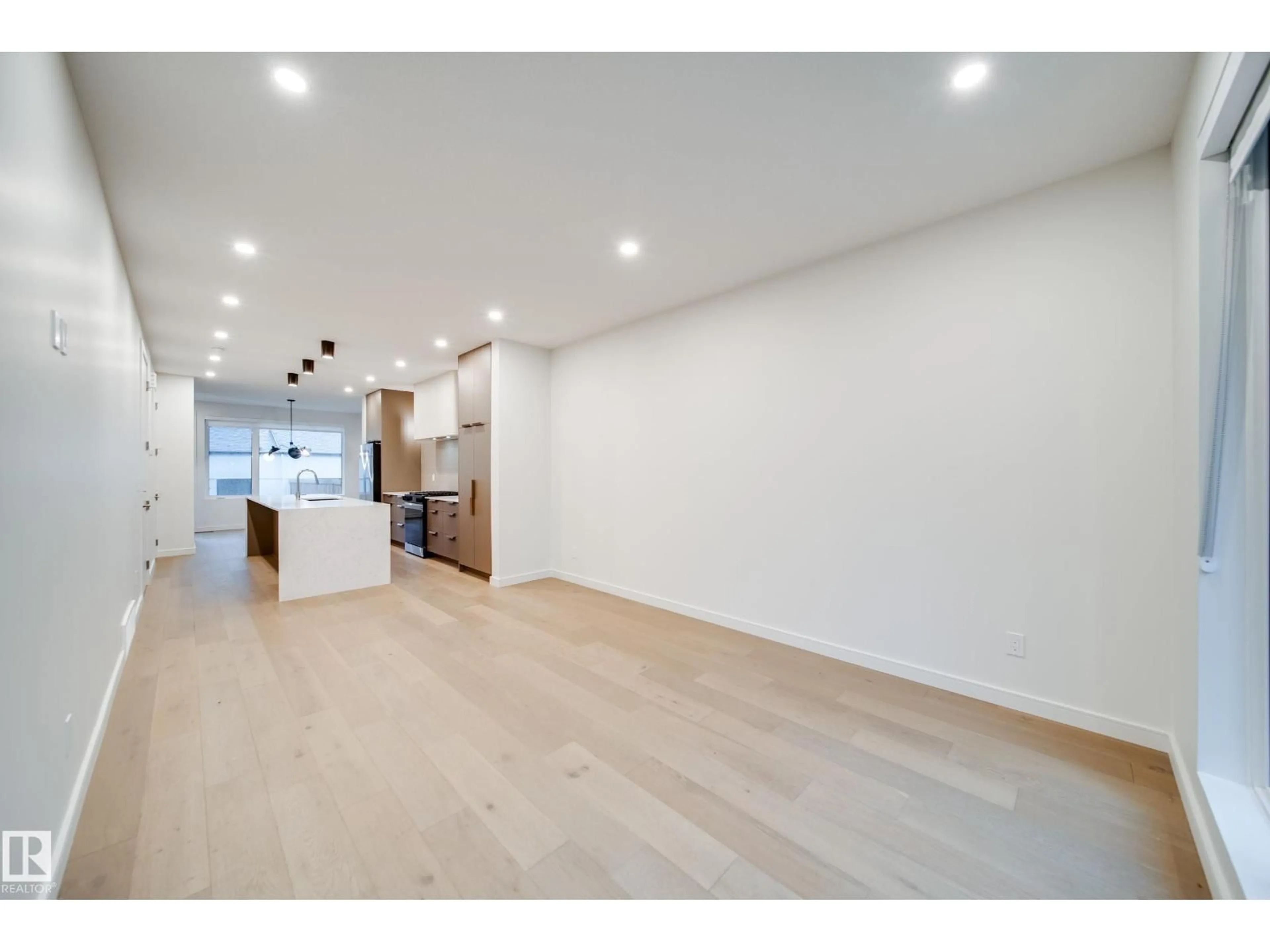 Open concept kitchen, wood/laminate floor for NW - 8719 83 AV, Edmonton Alberta T6C1B2