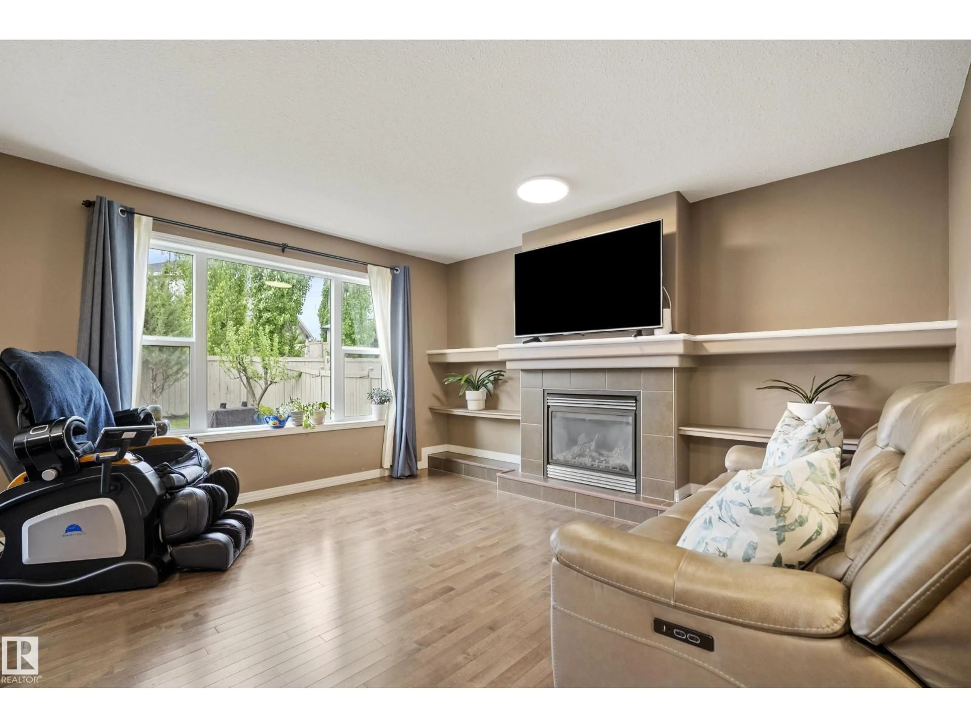 Living room with furniture, wood/laminate floor for 6715 19 AV, Edmonton Alberta T6X0L9