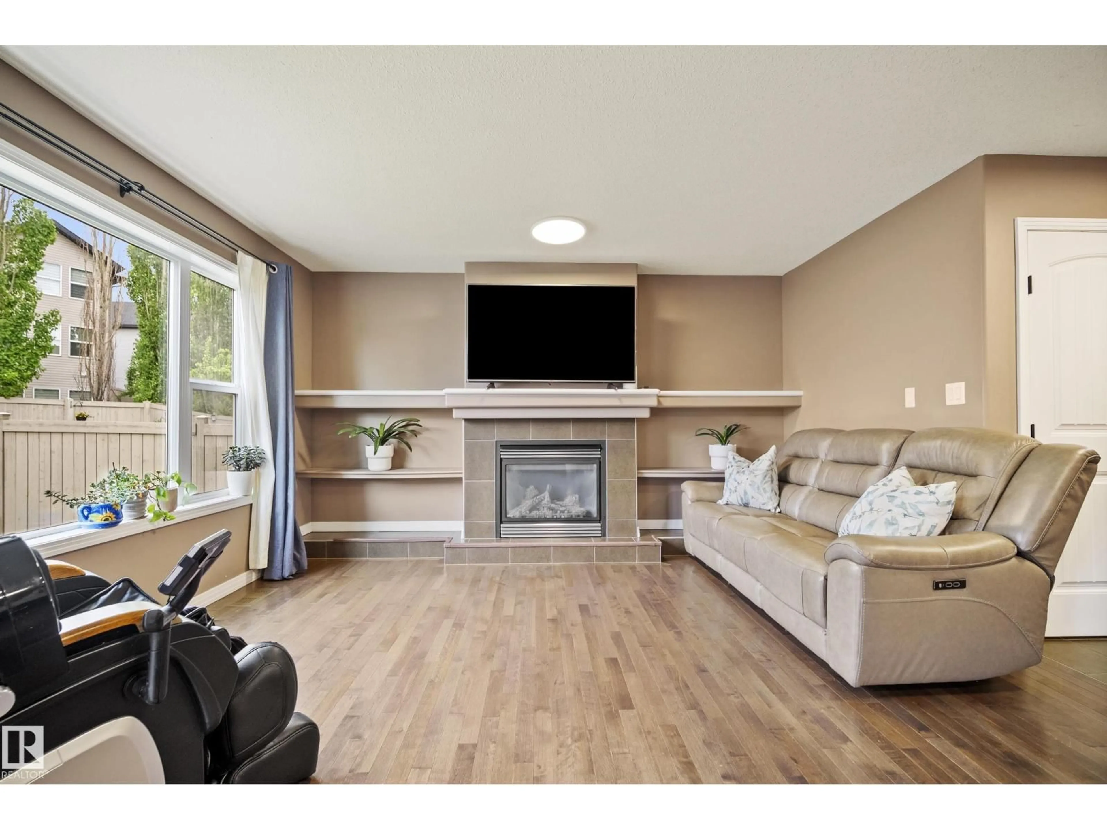 Living room with furniture, wood/laminate floor for 6715 19 AV, Edmonton Alberta T6X0L9