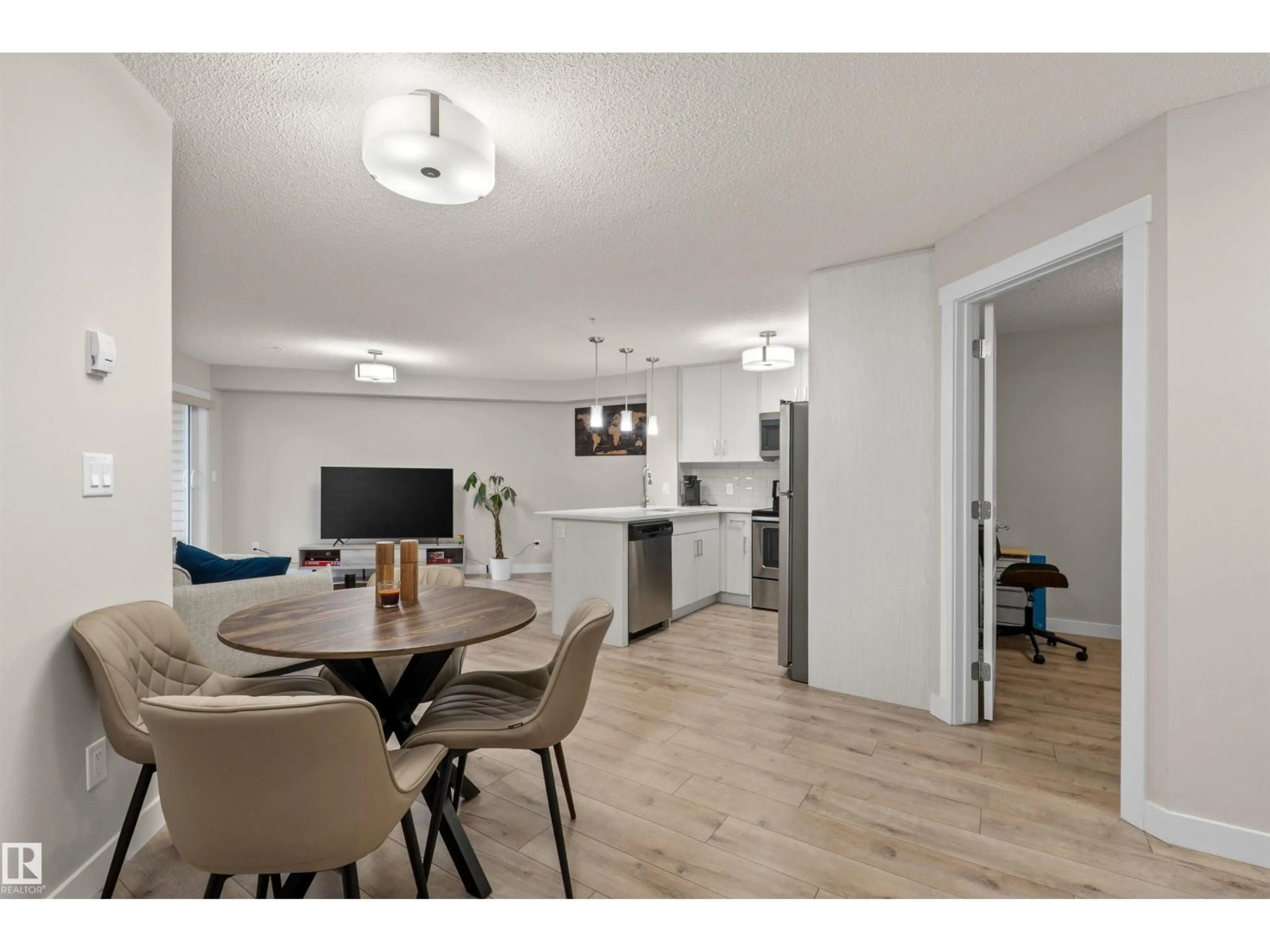 Open concept kitchen, wood/laminate floor for #210 - 2229 44 AV NW, Edmonton Alberta T6T0W6