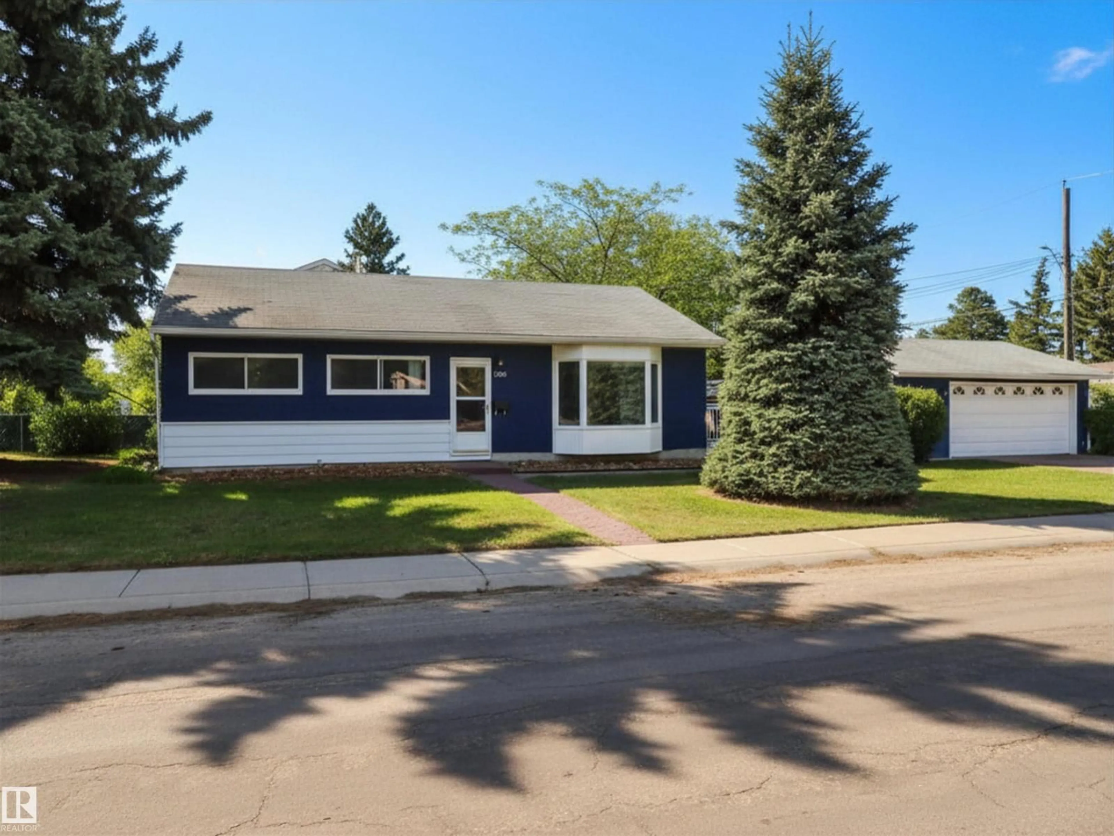Home with vinyl exterior material, street for 13208 130TH AV, Edmonton Alberta T5L3L7