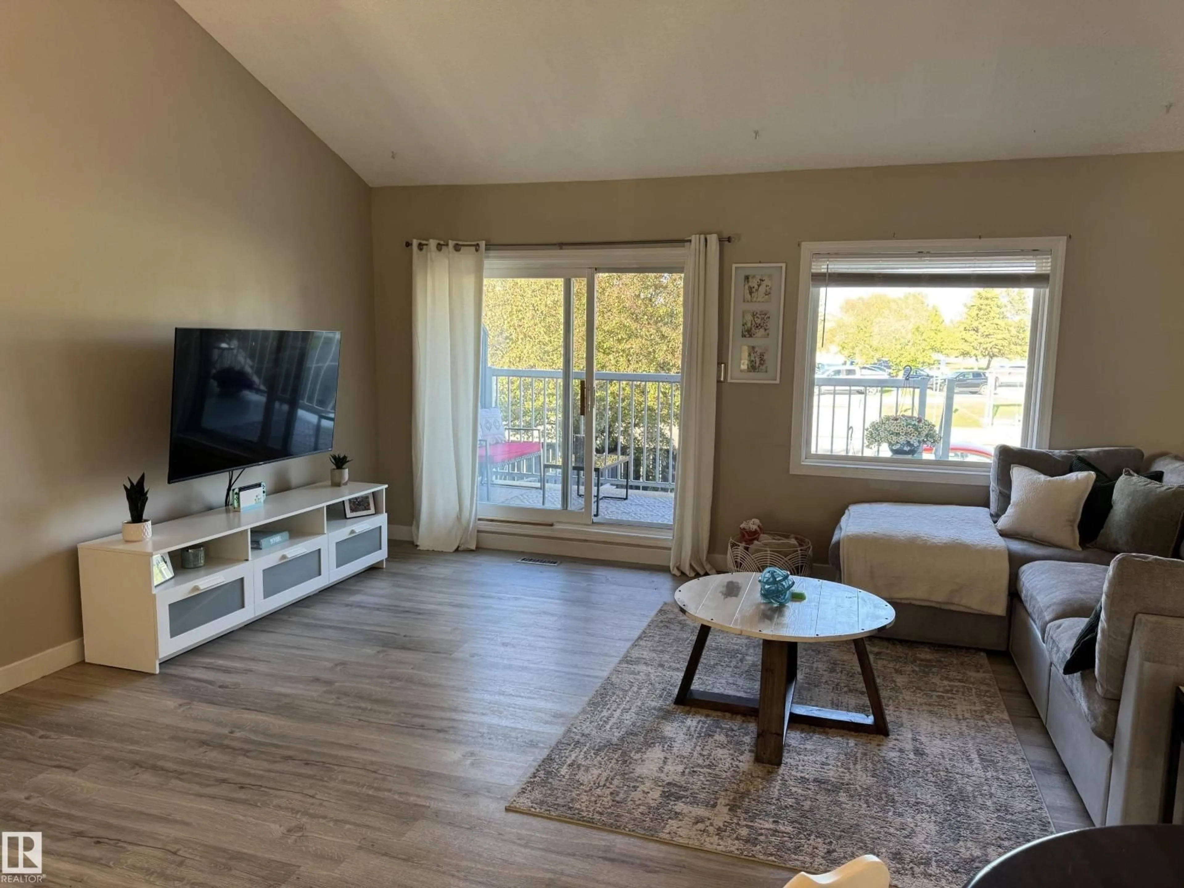 Living room with furniture, wood/laminate floor for 3 - 6220 172 ST, Edmonton Alberta T5T3R4