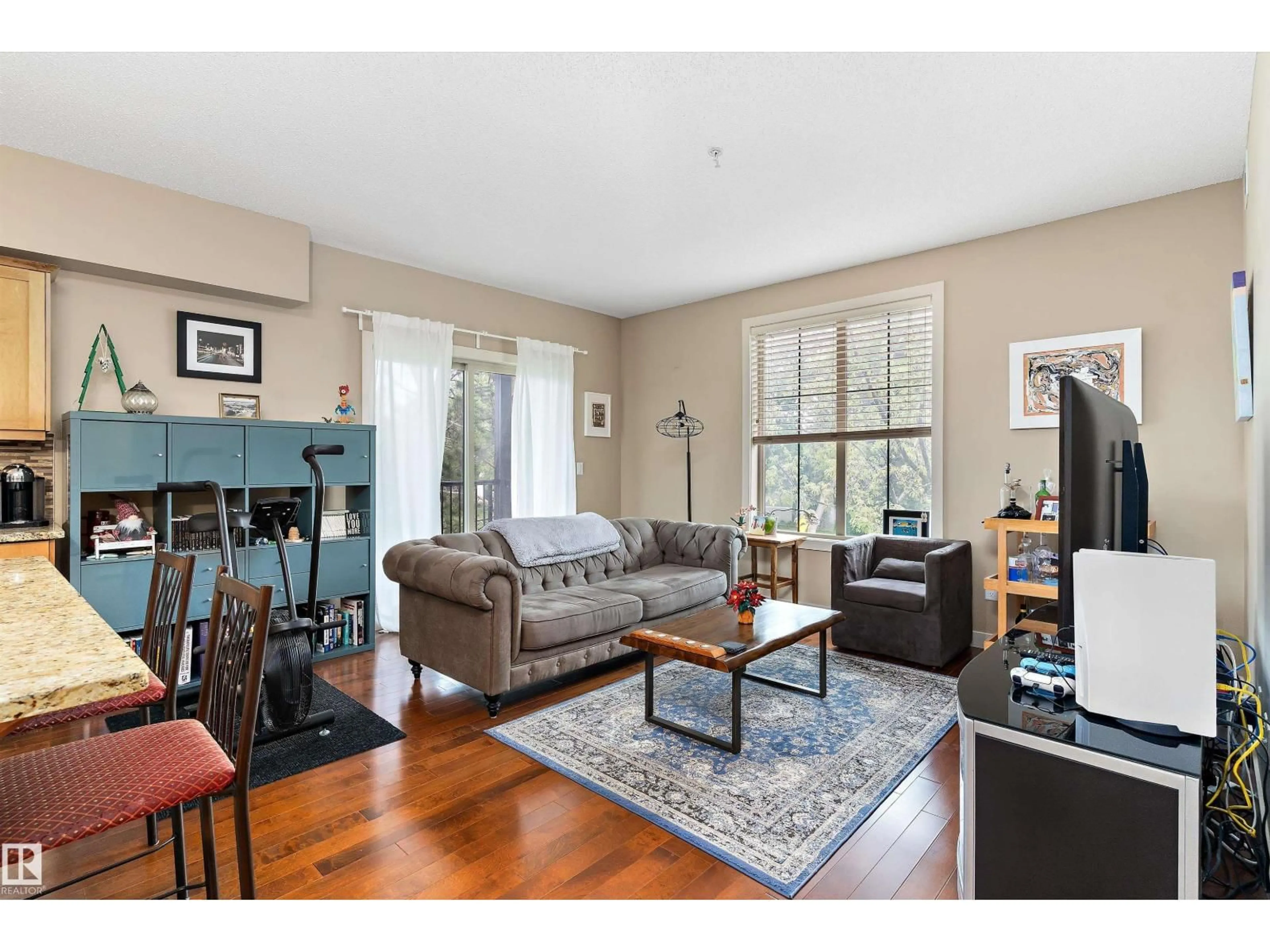 Living room with furniture, wood/laminate floor for #208 - 10520 56 AV, Edmonton Alberta T6H0X7