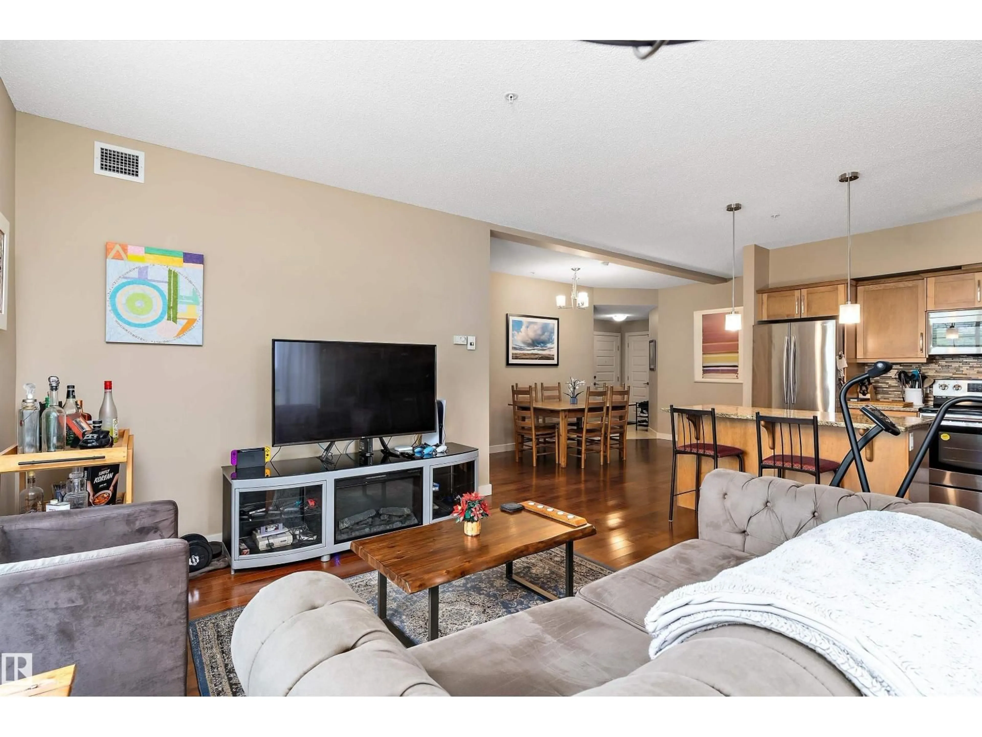 Living room with furniture, wood/laminate floor for #208 - 10520 56 AV, Edmonton Alberta T6H0X7