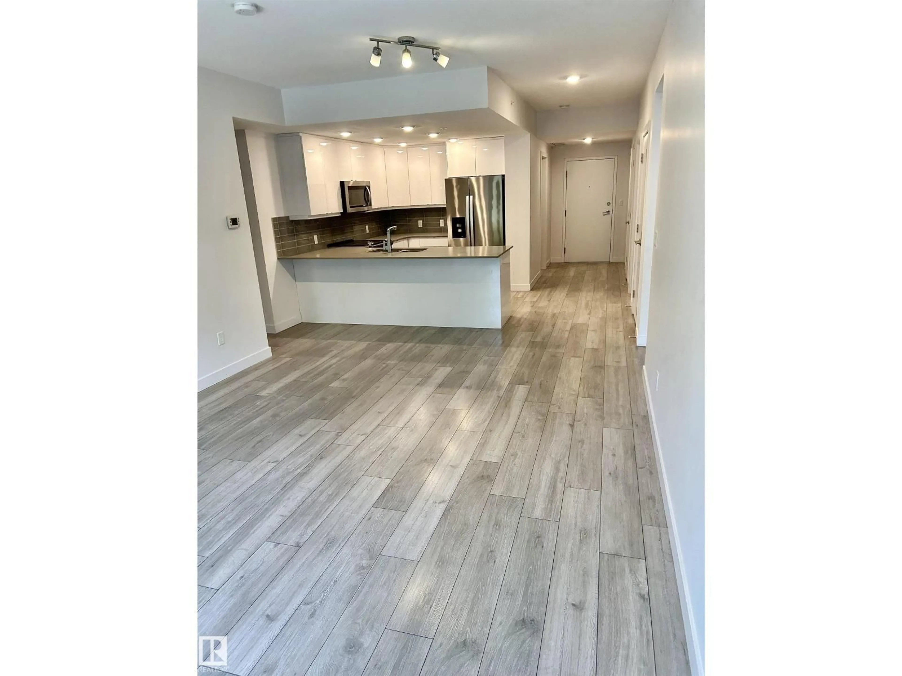 Open concept kitchen, wood/laminate floor for #203 - 8510 90 ST, Edmonton Alberta T6C3L5