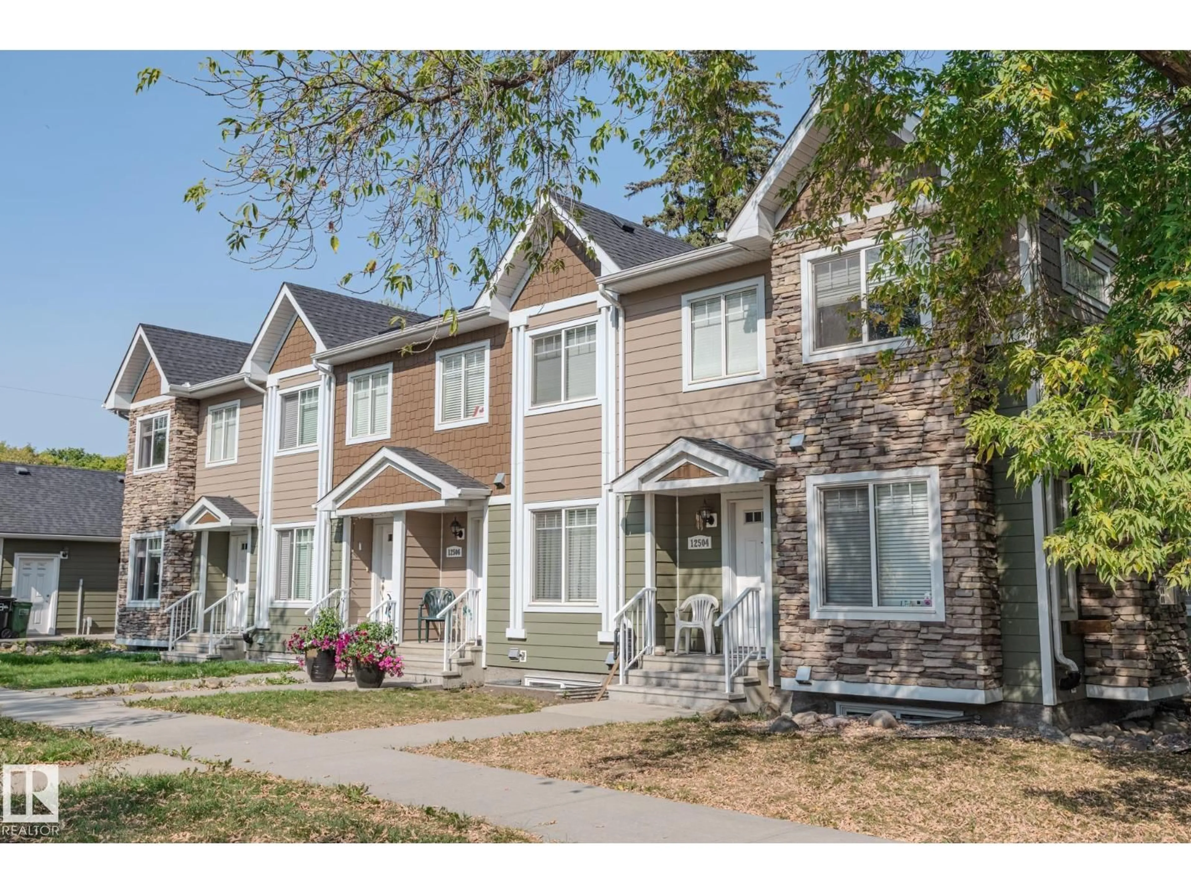 Home with vinyl exterior material, street for 12504 119 AV, Edmonton Alberta T5L2Z5