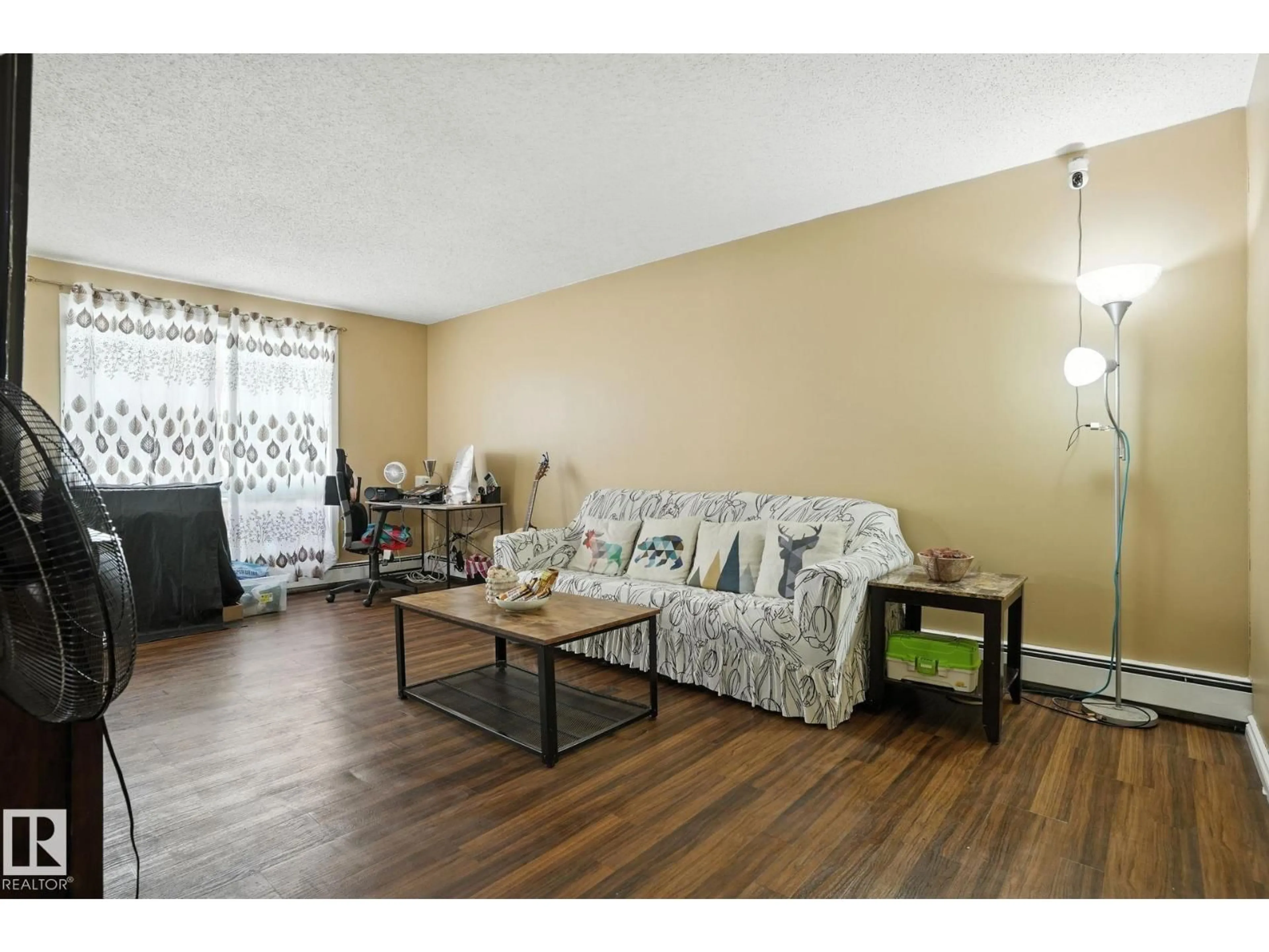Living room with furniture, wood/laminate floor for 201 - 11046 130 ST NW, Edmonton Alberta T5M0Z7