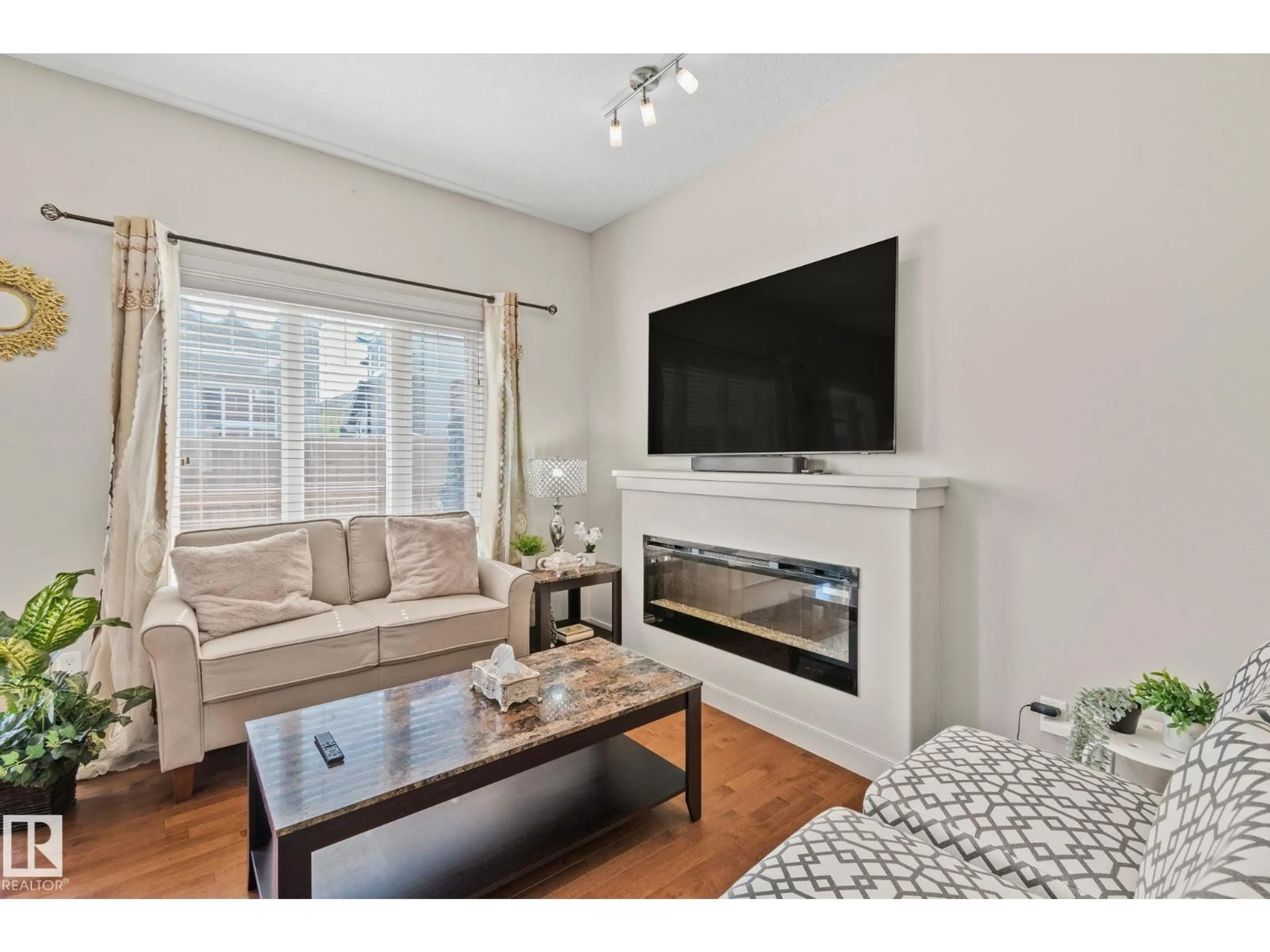 Living room with furniture, wood/laminate floor for #2 - 450 MCCONACHIE WY, Edmonton Alberta T5Y0S8