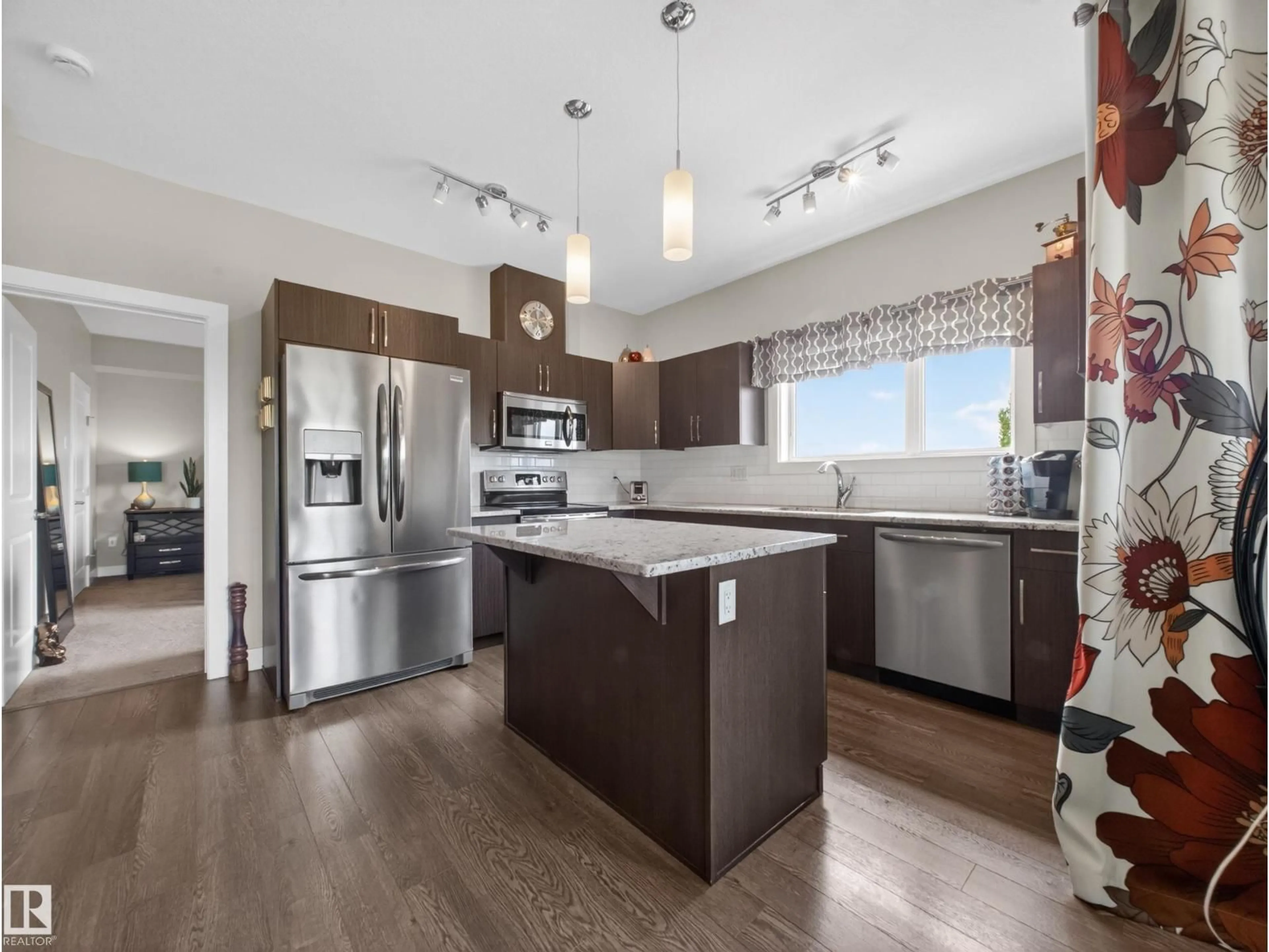 Open concept kitchen, wood/laminate floor for 5001 - 408 ETON BV, Sherwood Park Alberta T8H0N7