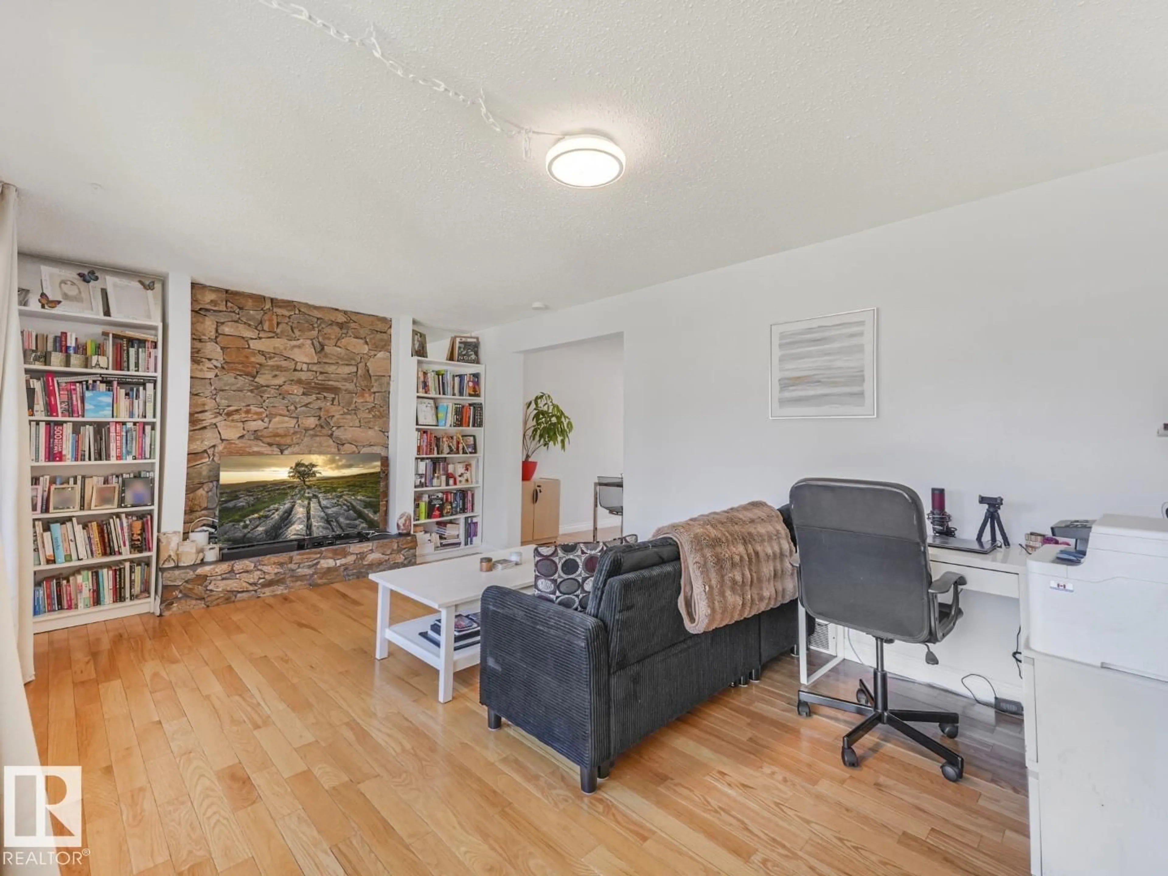 Living room with furniture, wood/laminate floor for 10511 26 AV, Edmonton Alberta T6J4C1