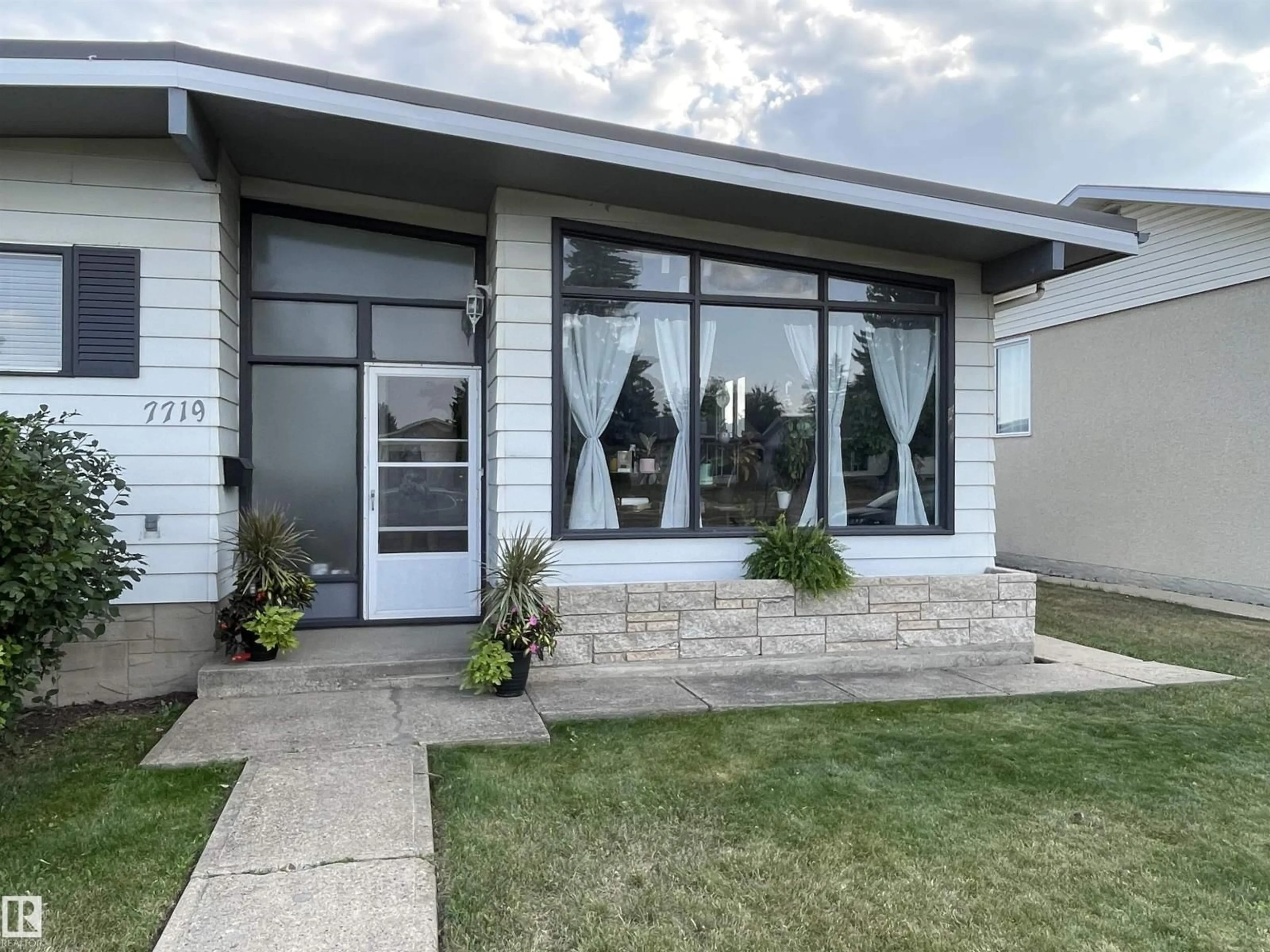 Home with vinyl exterior material, street for 7719 144 AV, Edmonton Alberta T5C2R9