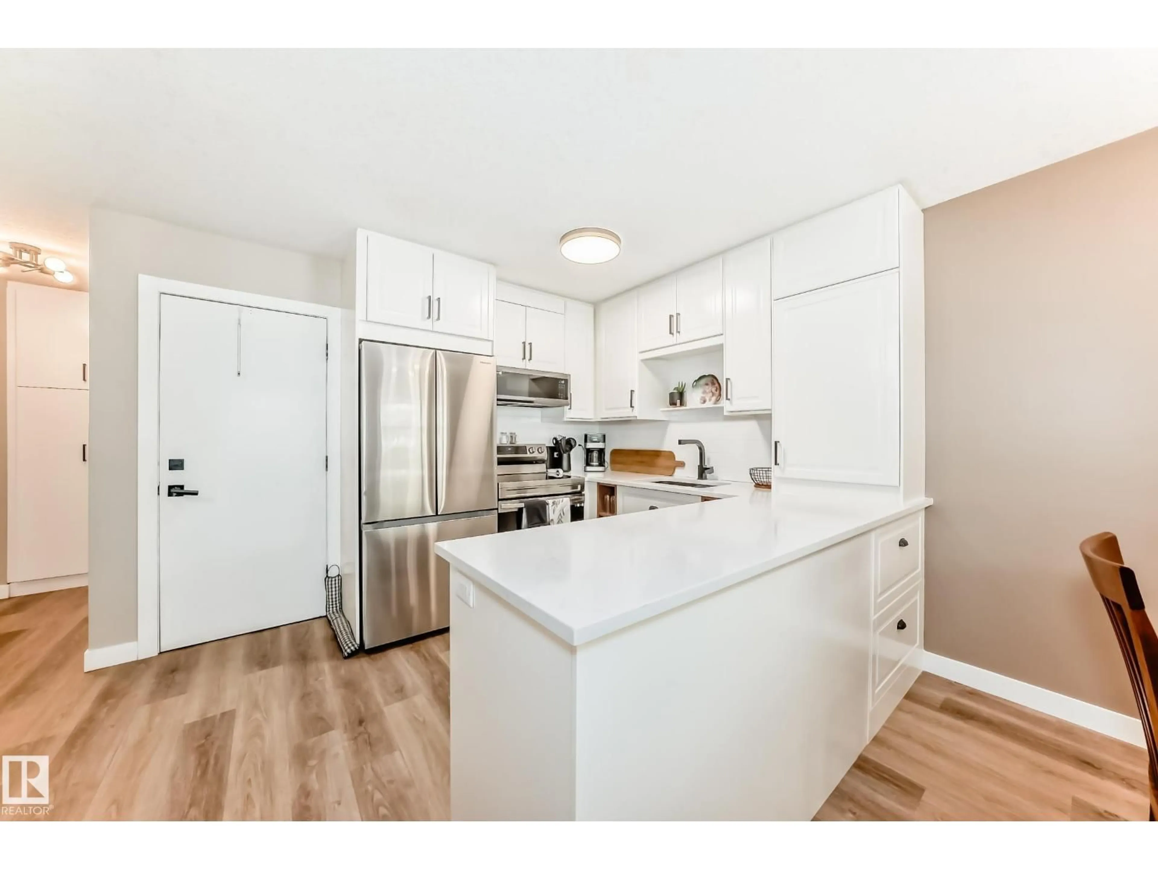 Open concept kitchen, wood/laminate floor for 10822 11 AV, Edmonton Alberta T6J6J1