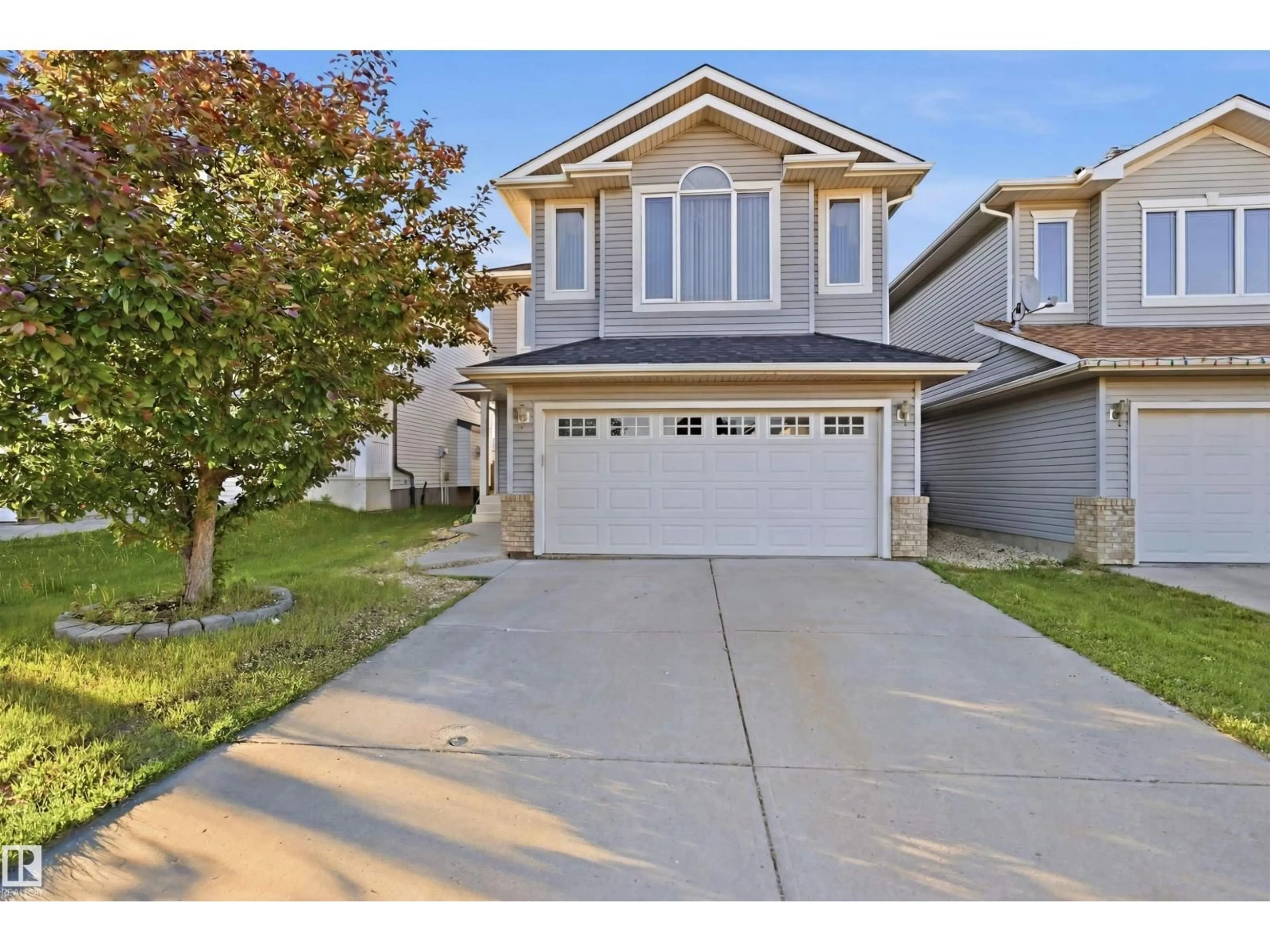 Home with vinyl exterior material, street for NW - 1560 37B AV, Edmonton Alberta T6T0E2