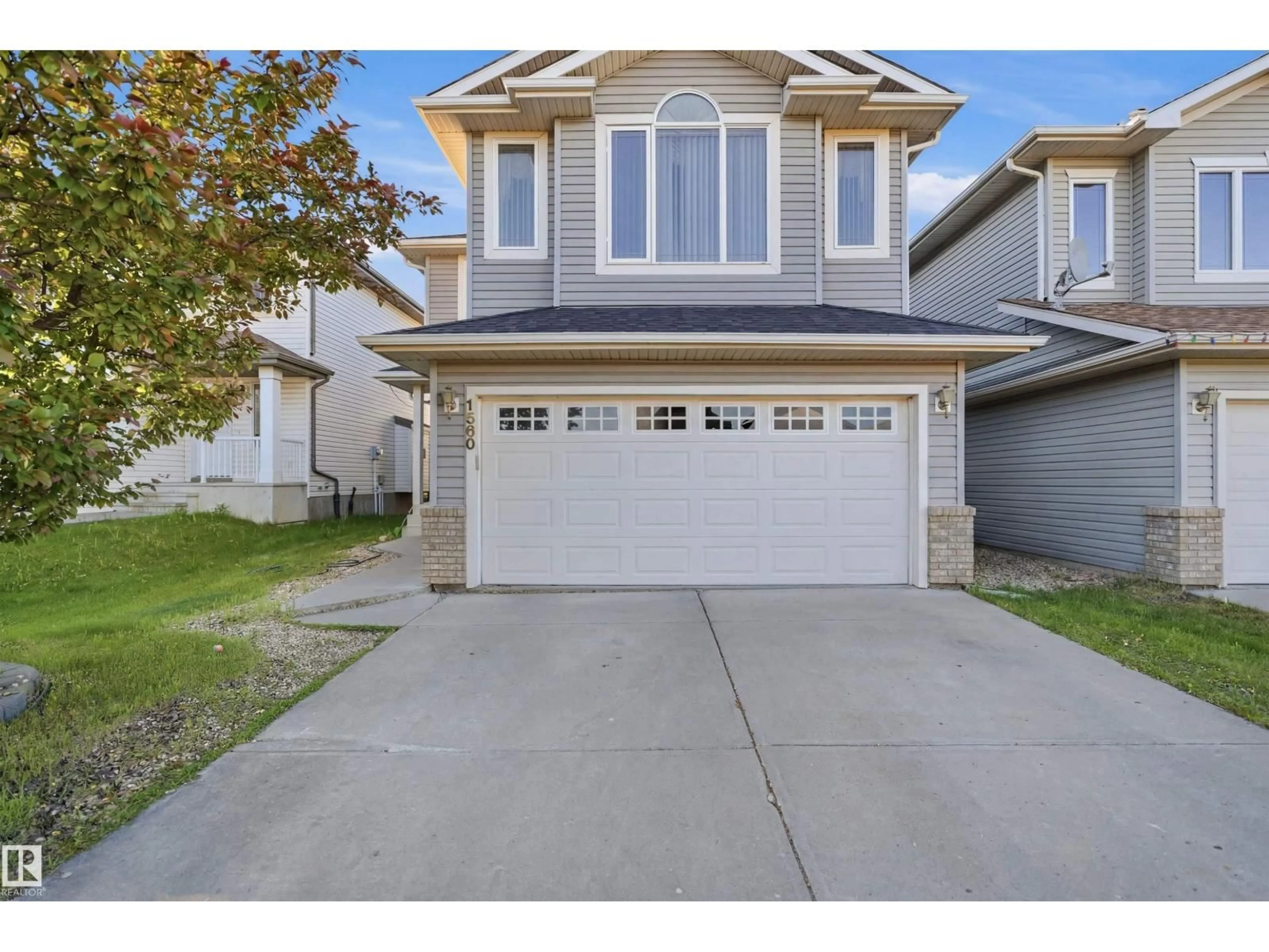 Home with vinyl exterior material, street for NW - 1560 37B AV, Edmonton Alberta T6T0E2
