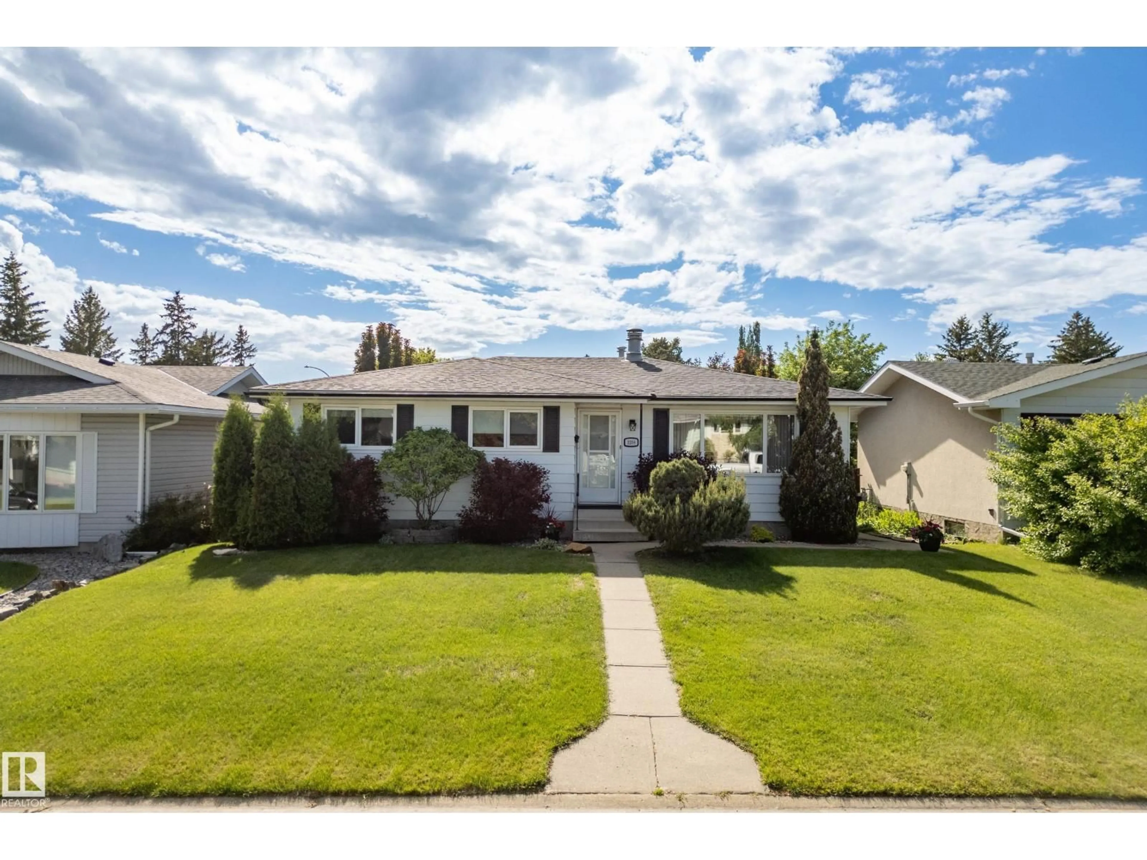 Home with vinyl exterior material, street for 3208 70 ST, Edmonton Alberta T6K1L2