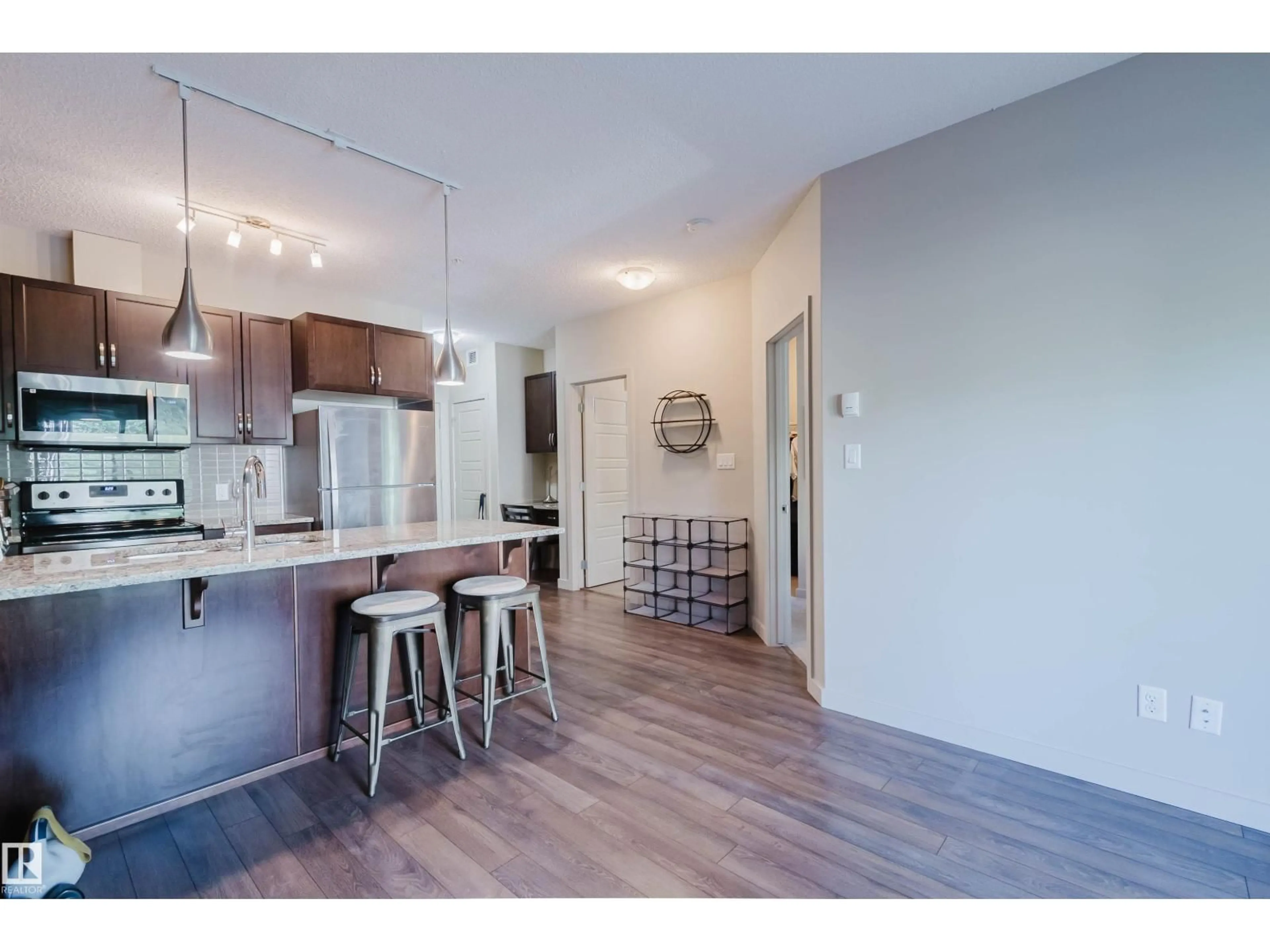 Open concept kitchen, wood/laminate floor for 217 - 508 GRIESBACH PR, Edmonton Alberta T5E6V9