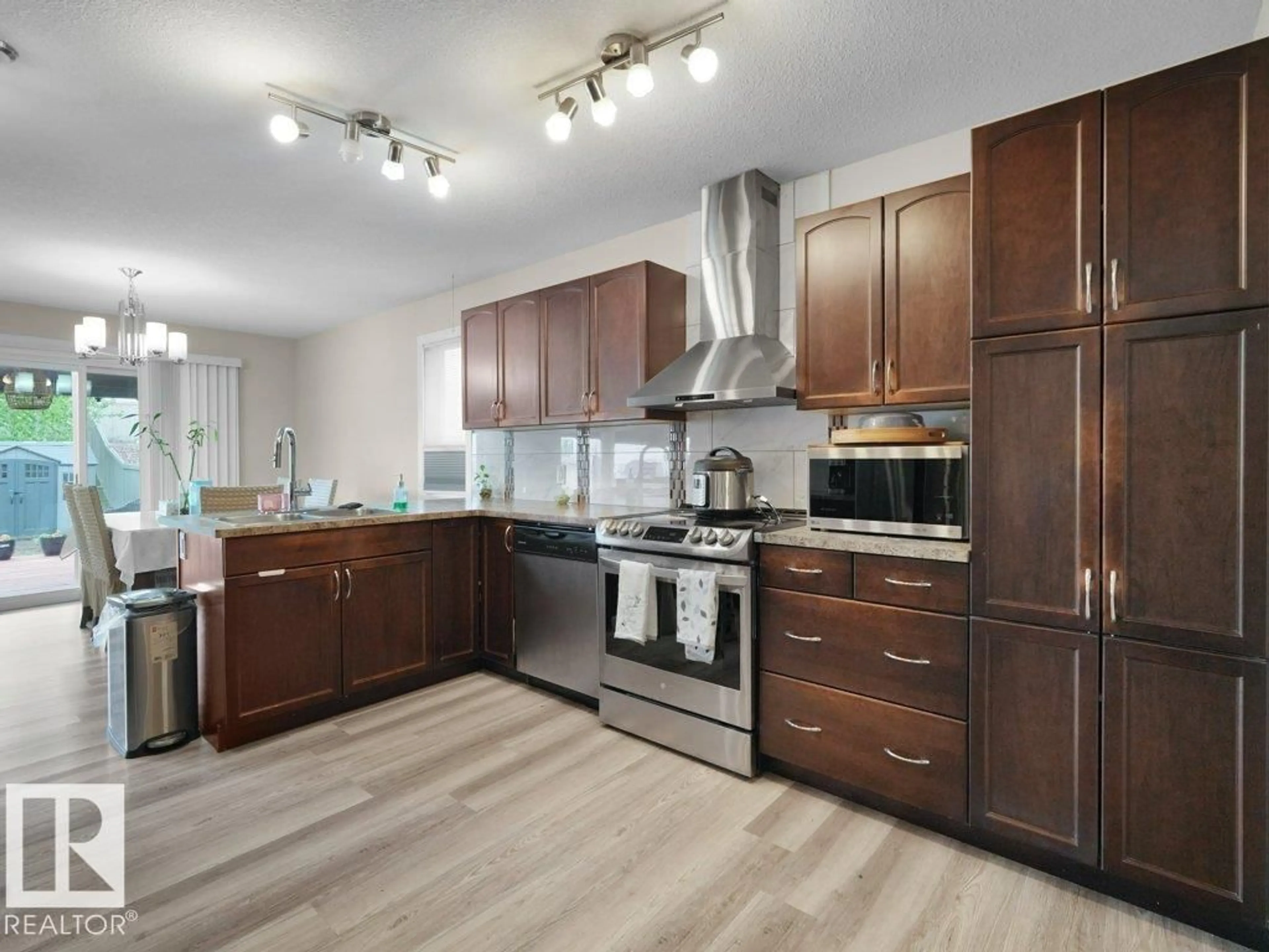 Open concept kitchen, wood/laminate floor for 3756 8 ST, Edmonton Alberta T6T0S1