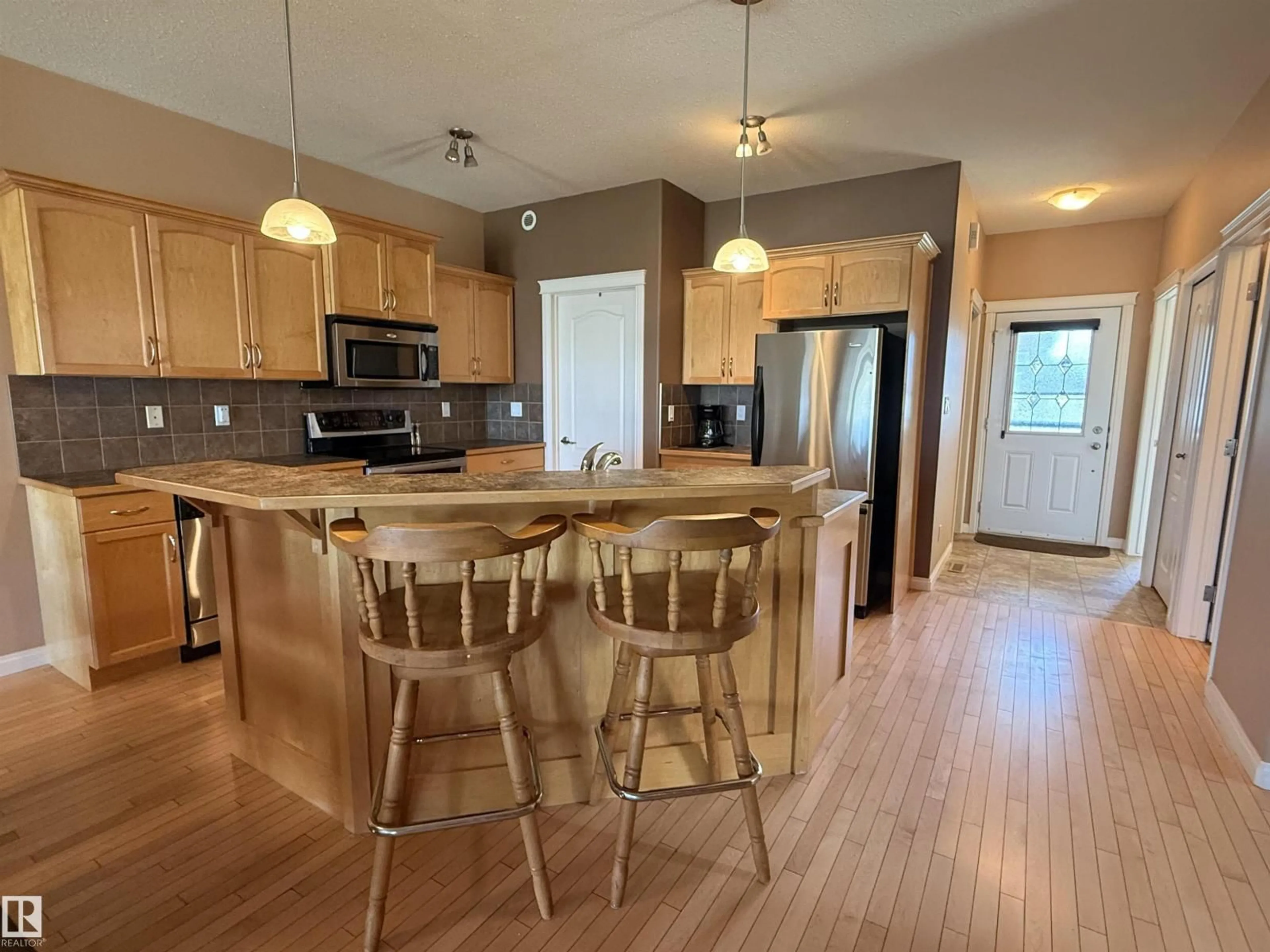 Open concept kitchen, wood/laminate floor for 3815 75 ST, Camrose Alberta T4V4C1