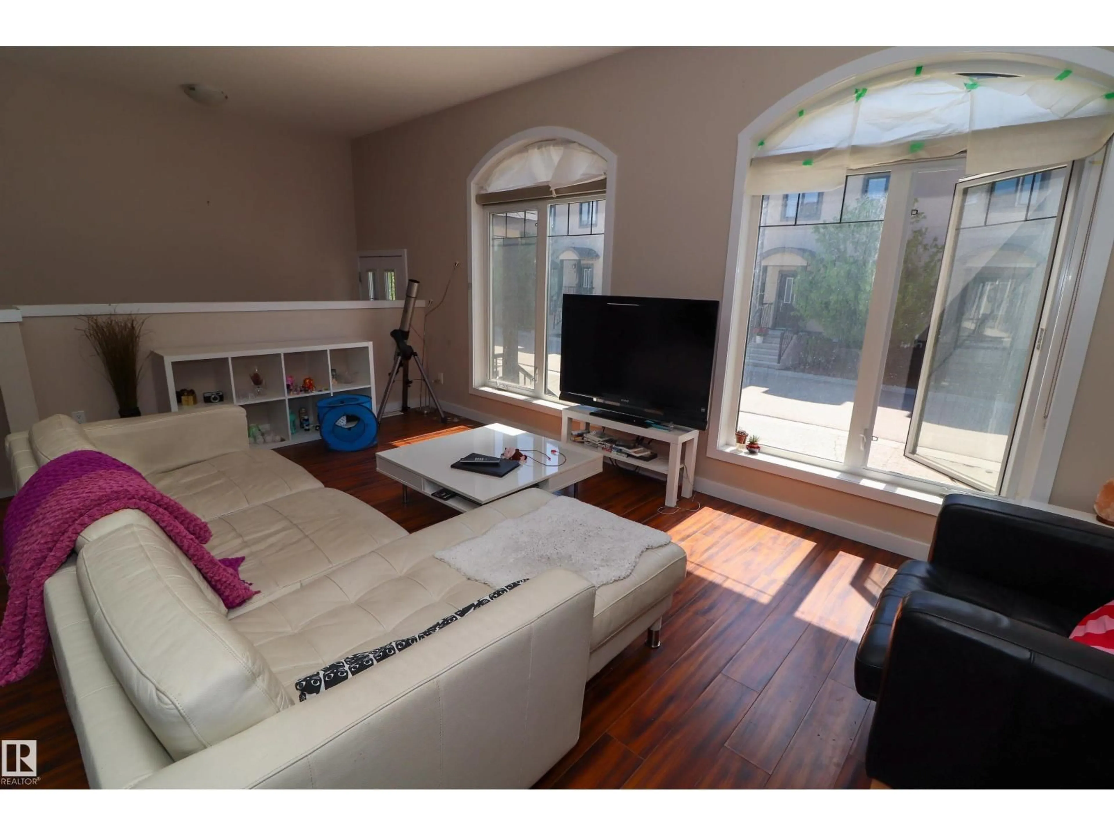 Living room with furniture, wood/laminate floor for #23 - 5873 MULLEN PL, Edmonton Alberta T6R0T5