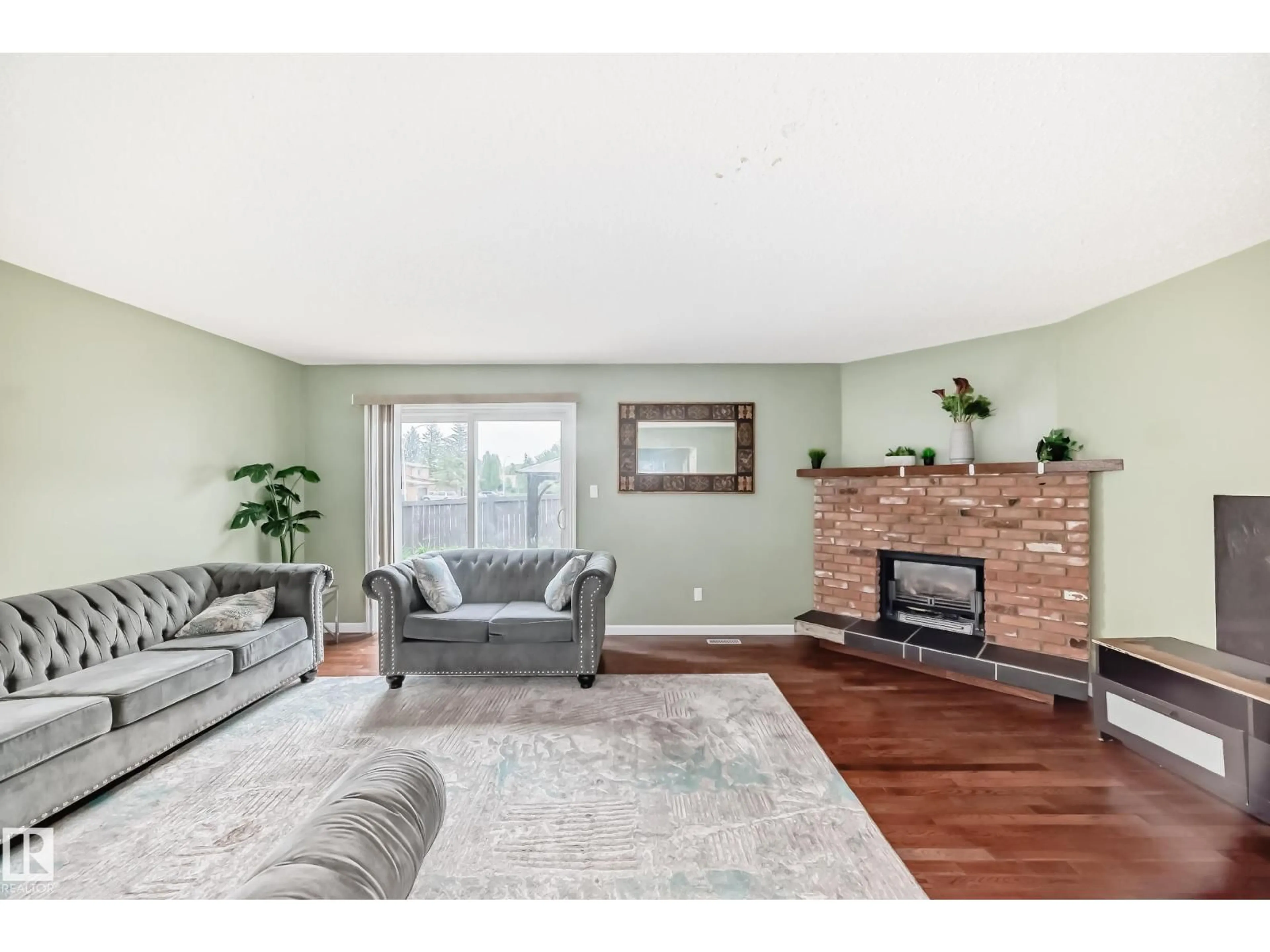 Living room with furniture, wood/laminate floor for NW - 13621 28 ST, Edmonton Alberta T5A4B5