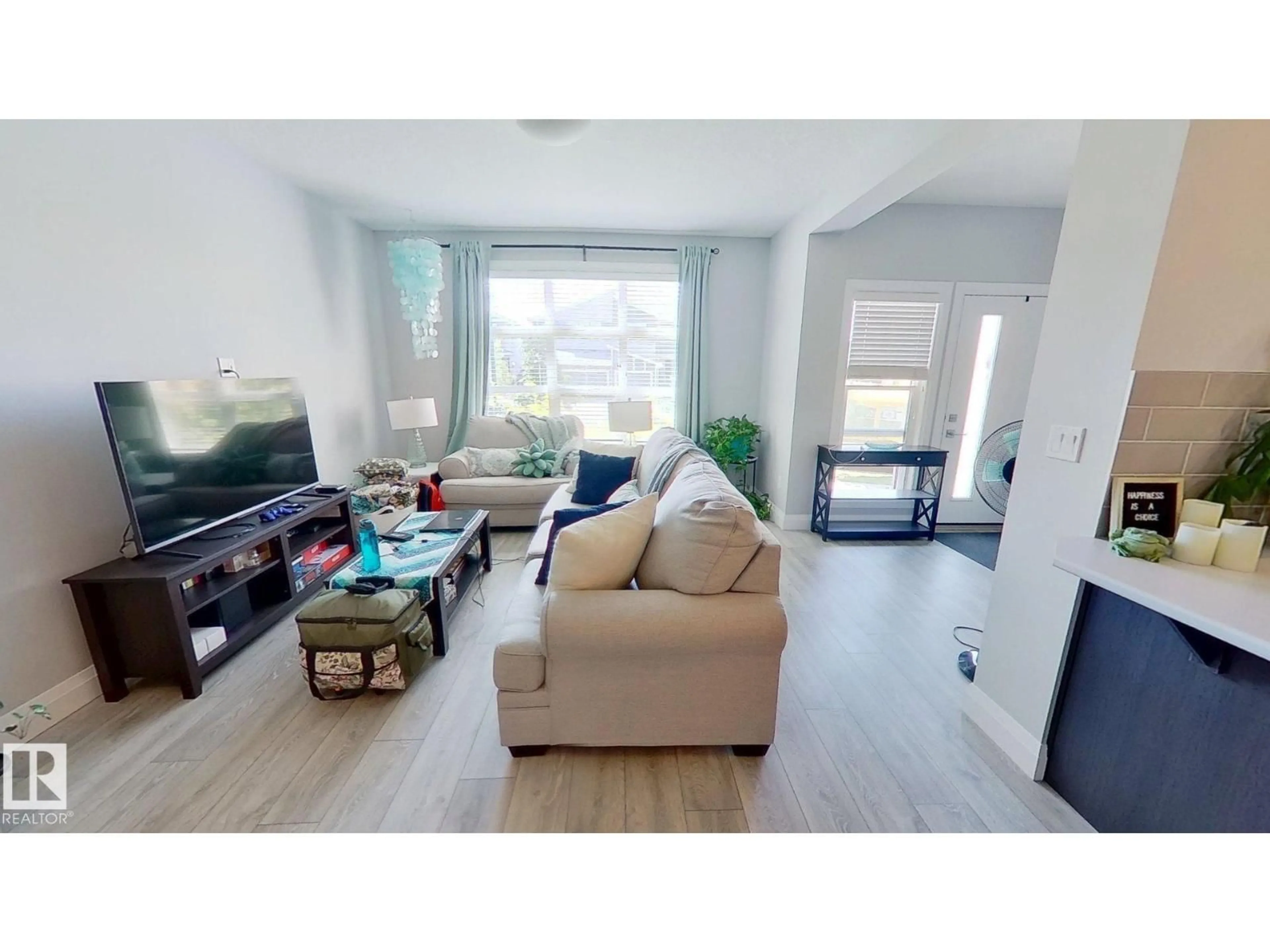 Living room with furniture, wood/laminate floor for 3632 8 AV, Edmonton Alberta T6X2G6
