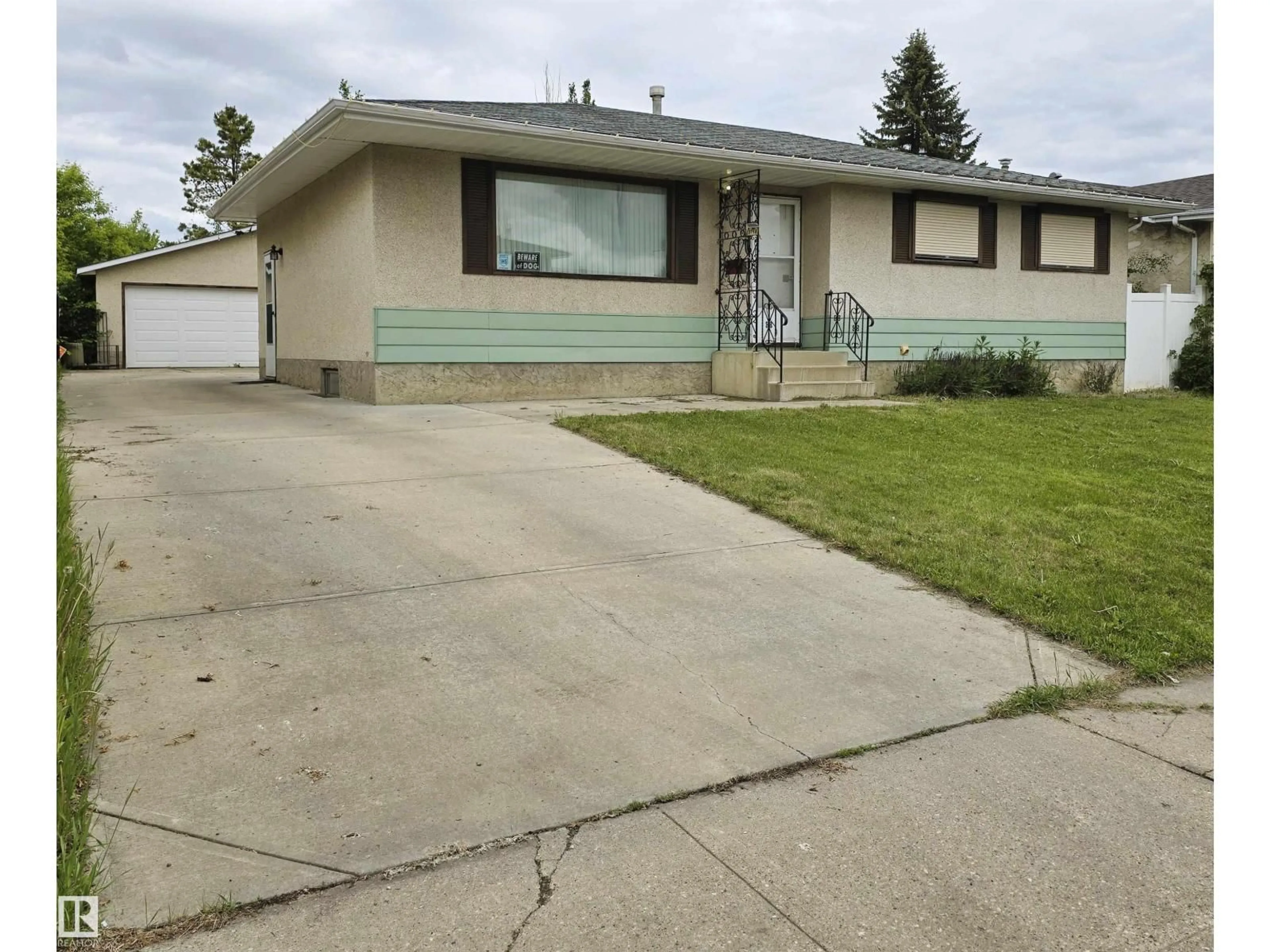 Home with vinyl exterior material, street for NW - 3718 136A AV, Edmonton Alberta T5A2P4
